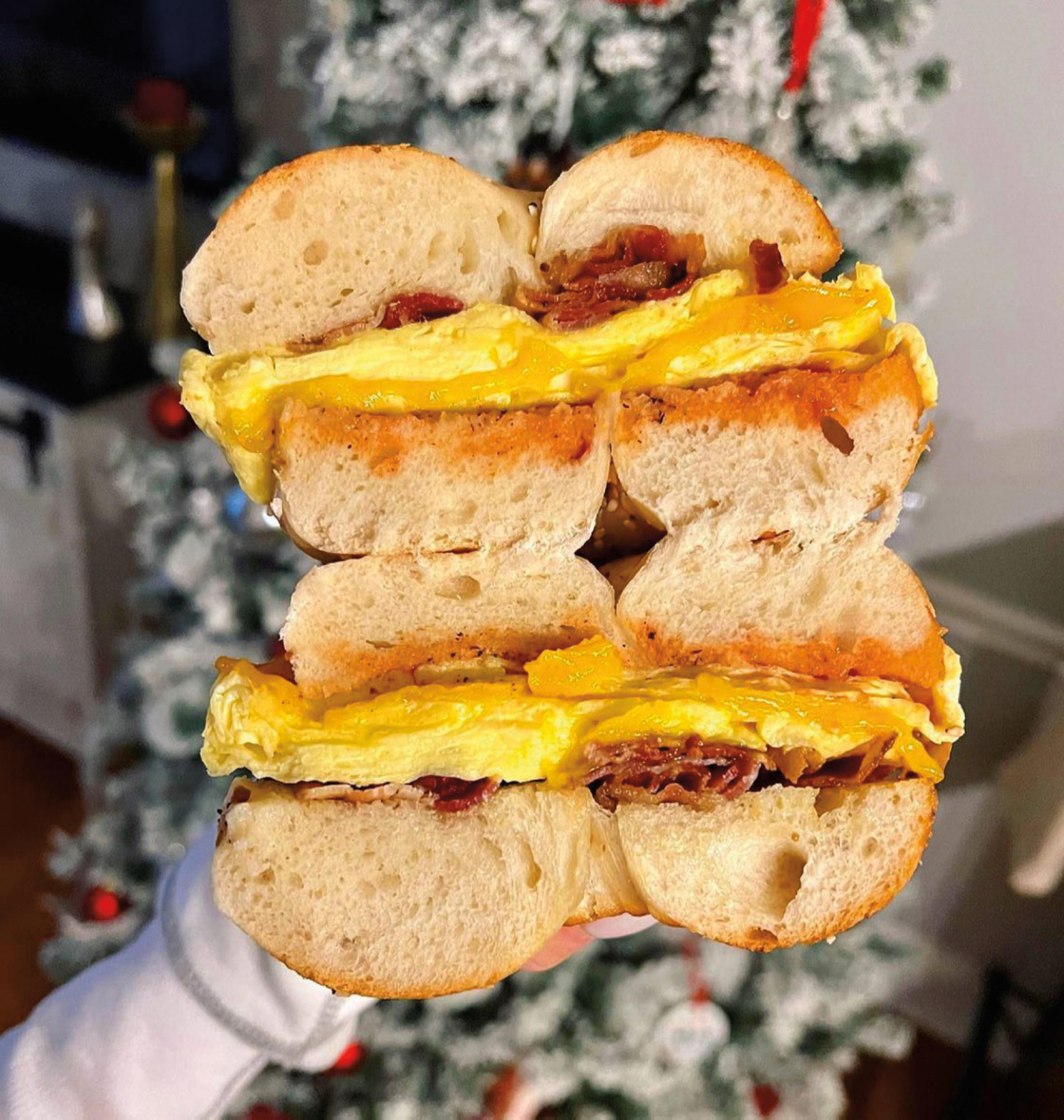bagel sandwich with meat, cheese and egg.