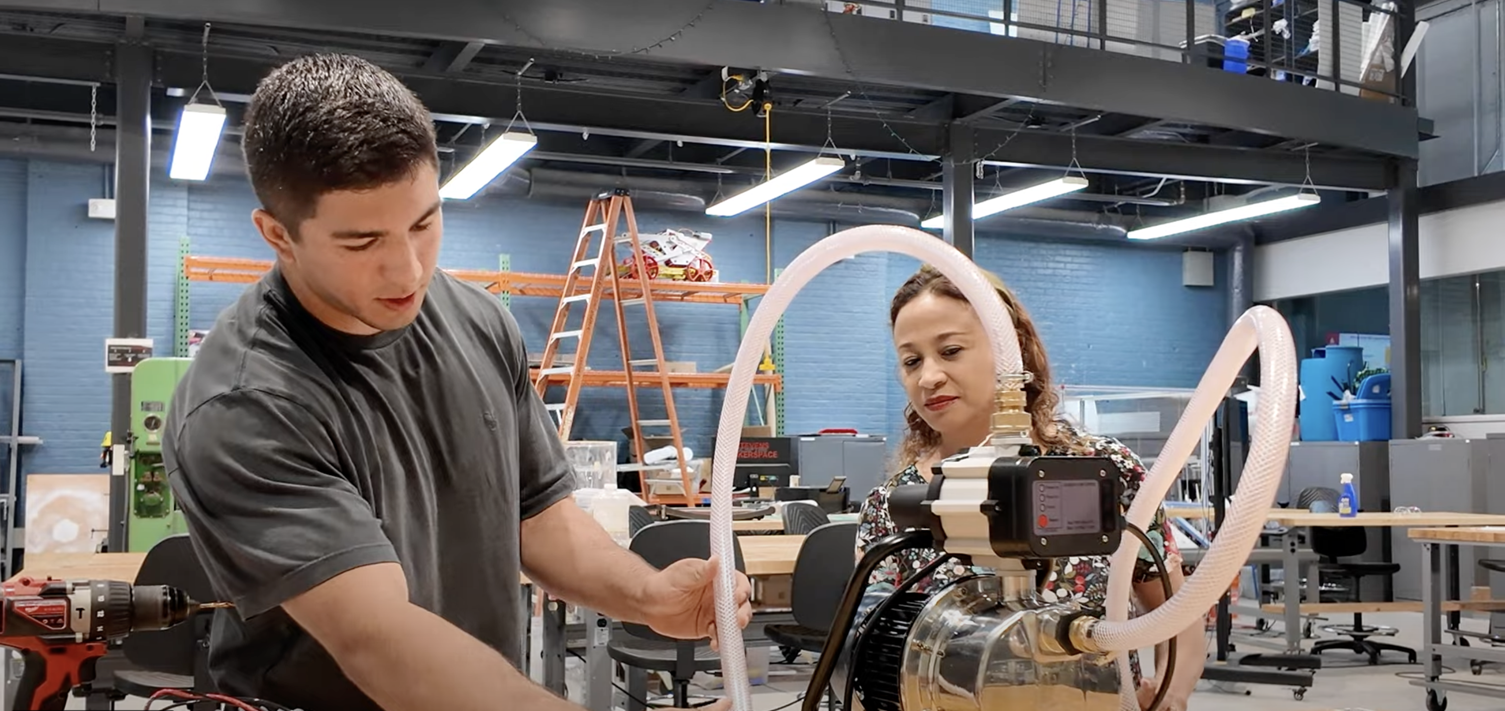 Student Harrison Hinojosa and Stevens Center for Sustainability Program Manager Rosita Nunez work on a water pressure project in the ABS Engineering Center.