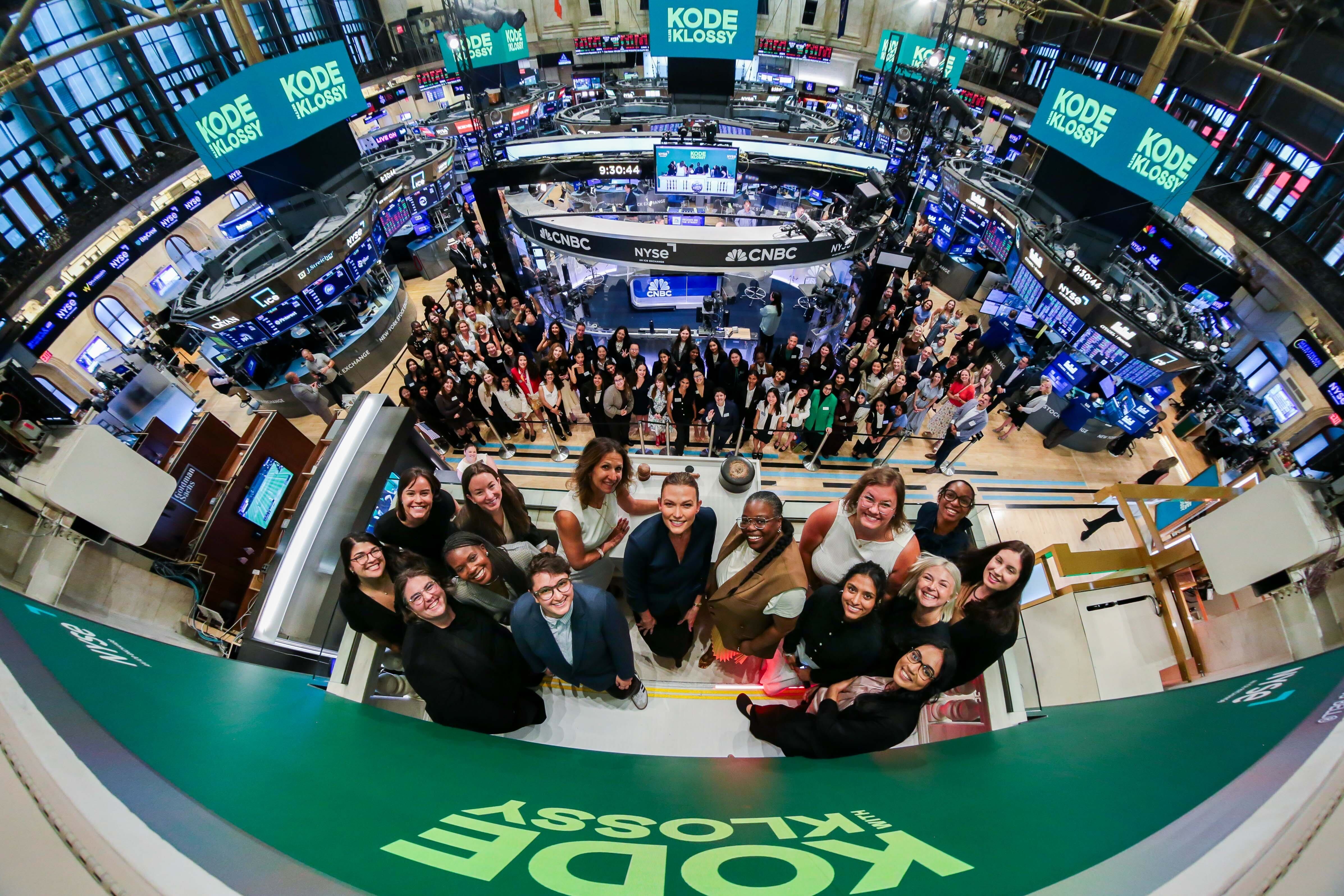A group of people stand at the New York Stock Exchange