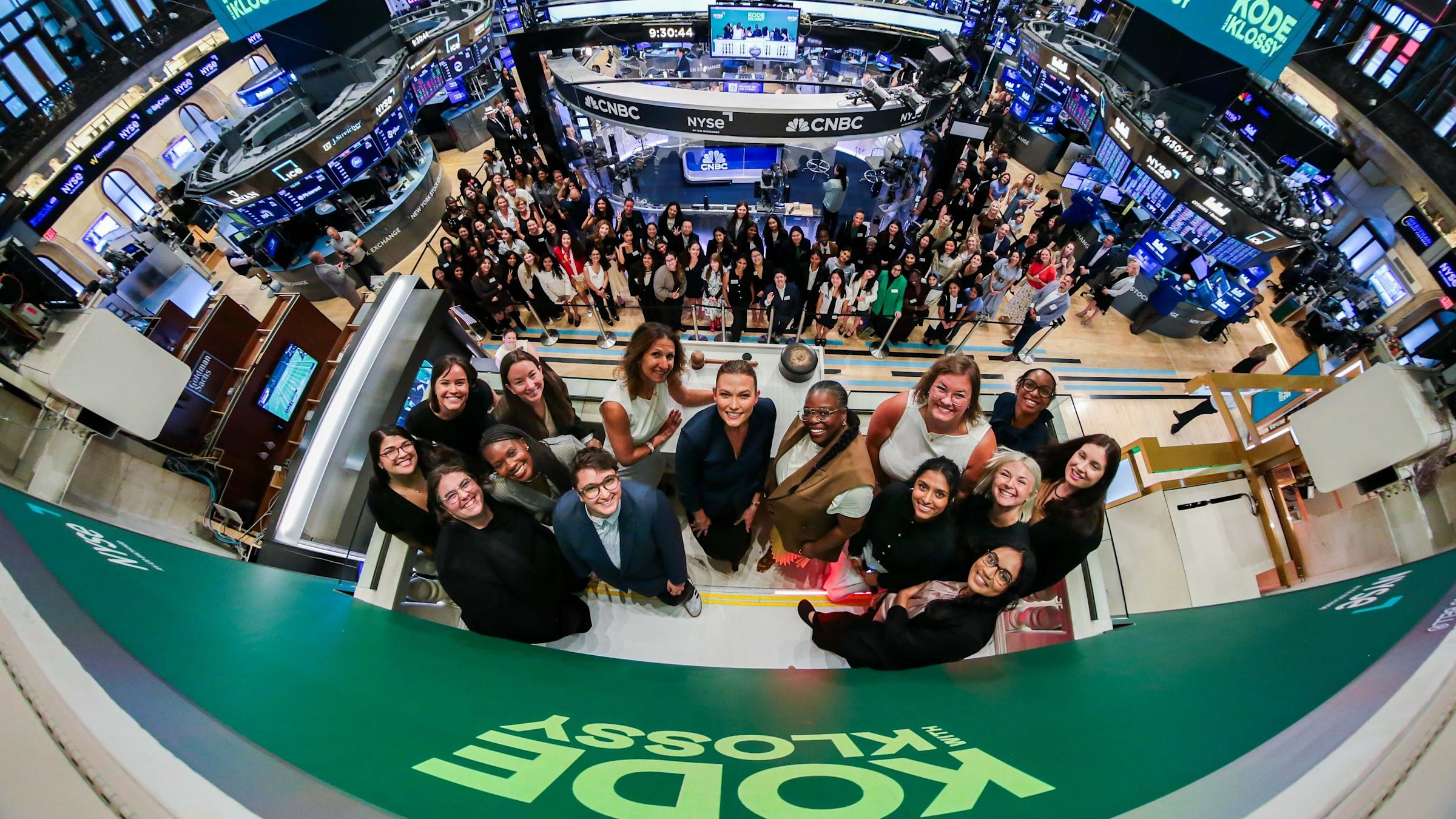 A group of people stand at the New York Stock Exchange