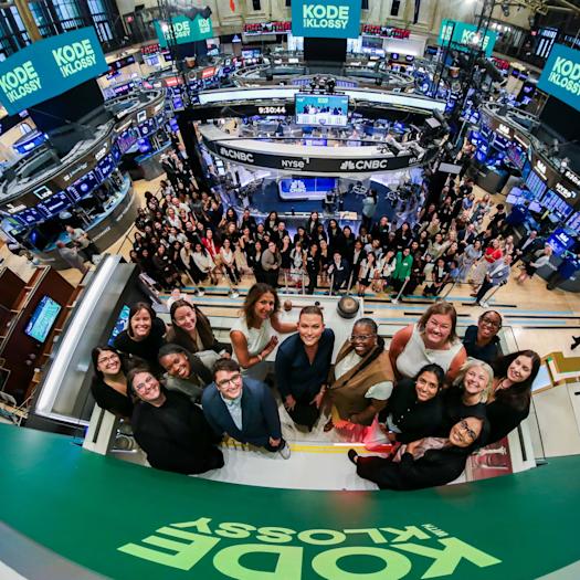 A group of people stand at the New York Stock Exchange