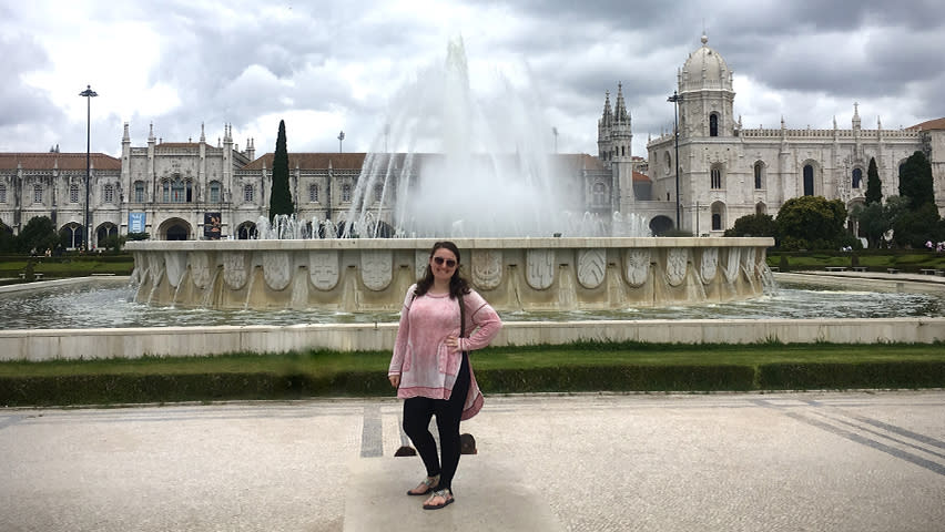 Devon Leslie in front of a fountain in Portugal.