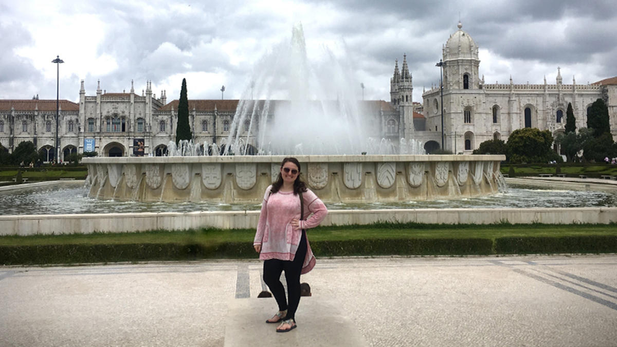 Devon Leslie in front of a fountain in Portugal.