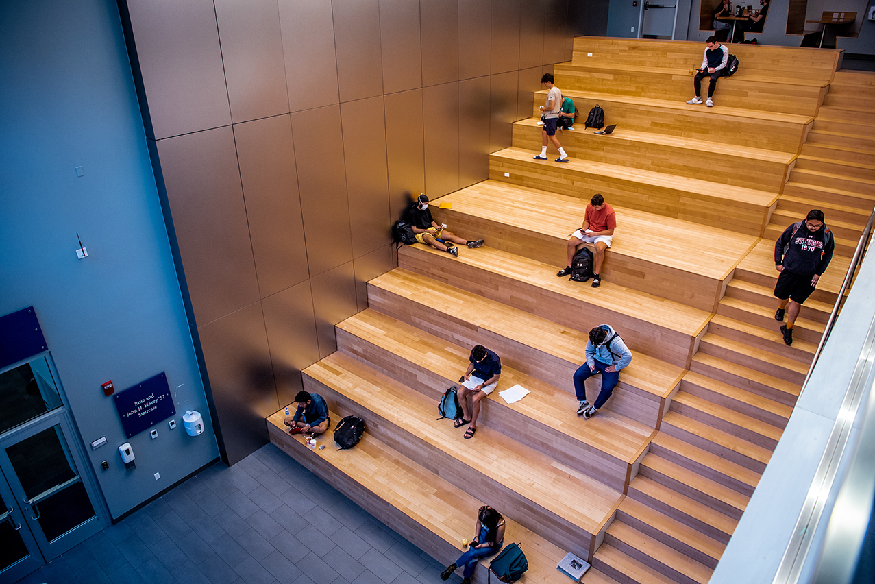 Students studying on staircase