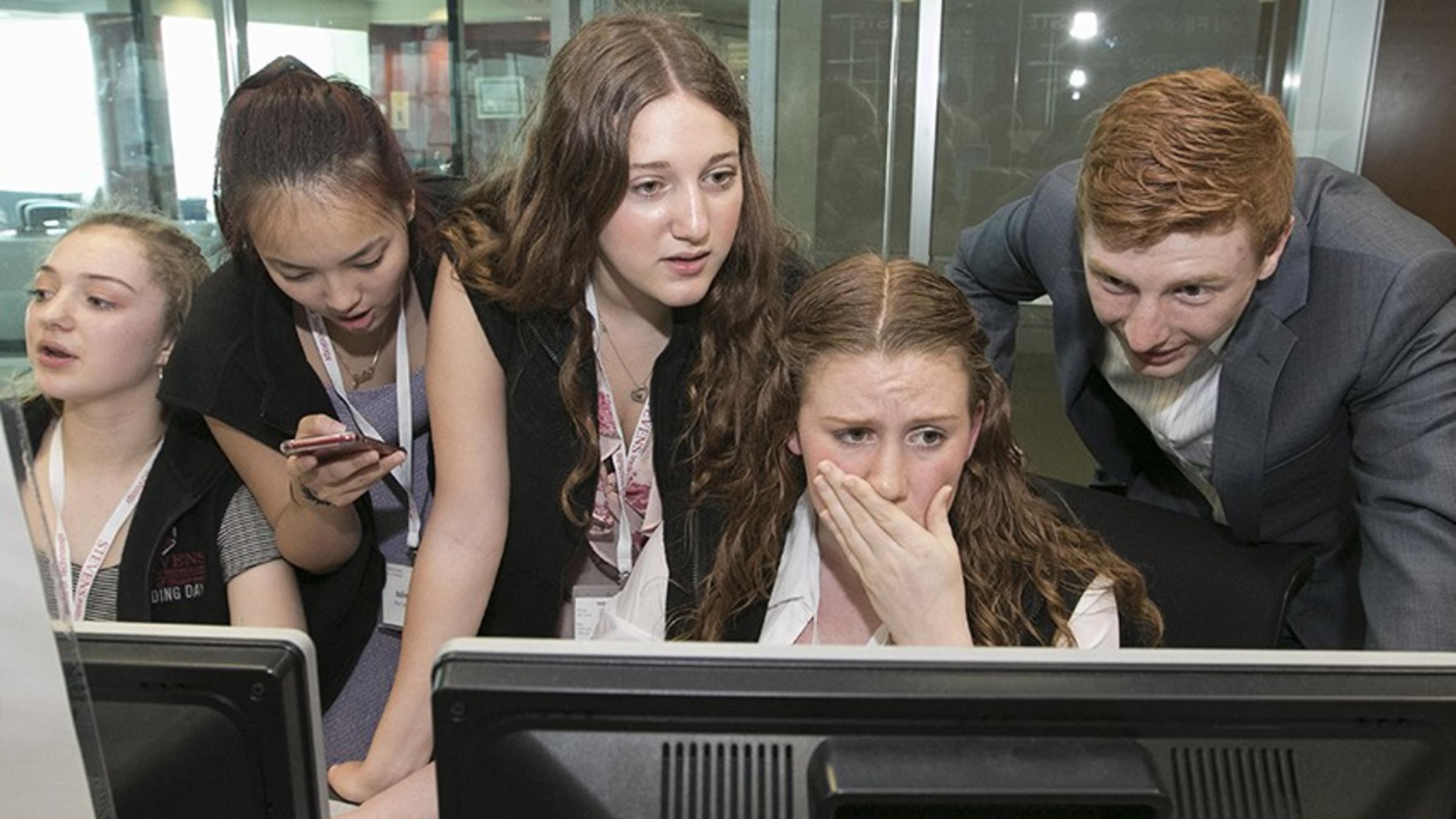 High school students using terminals in the Hanlon Lab at Stevens during Trading Day.
