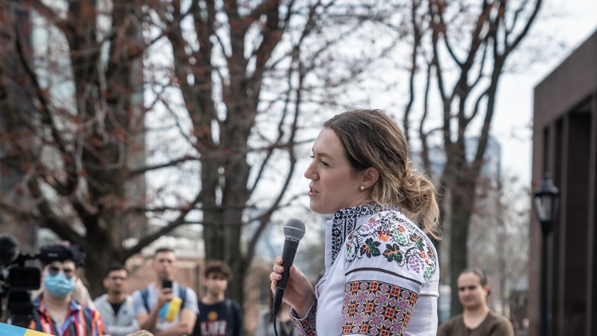 Nicole Malantchouk speaking in microphone at the Stevens Rally for Ukraine