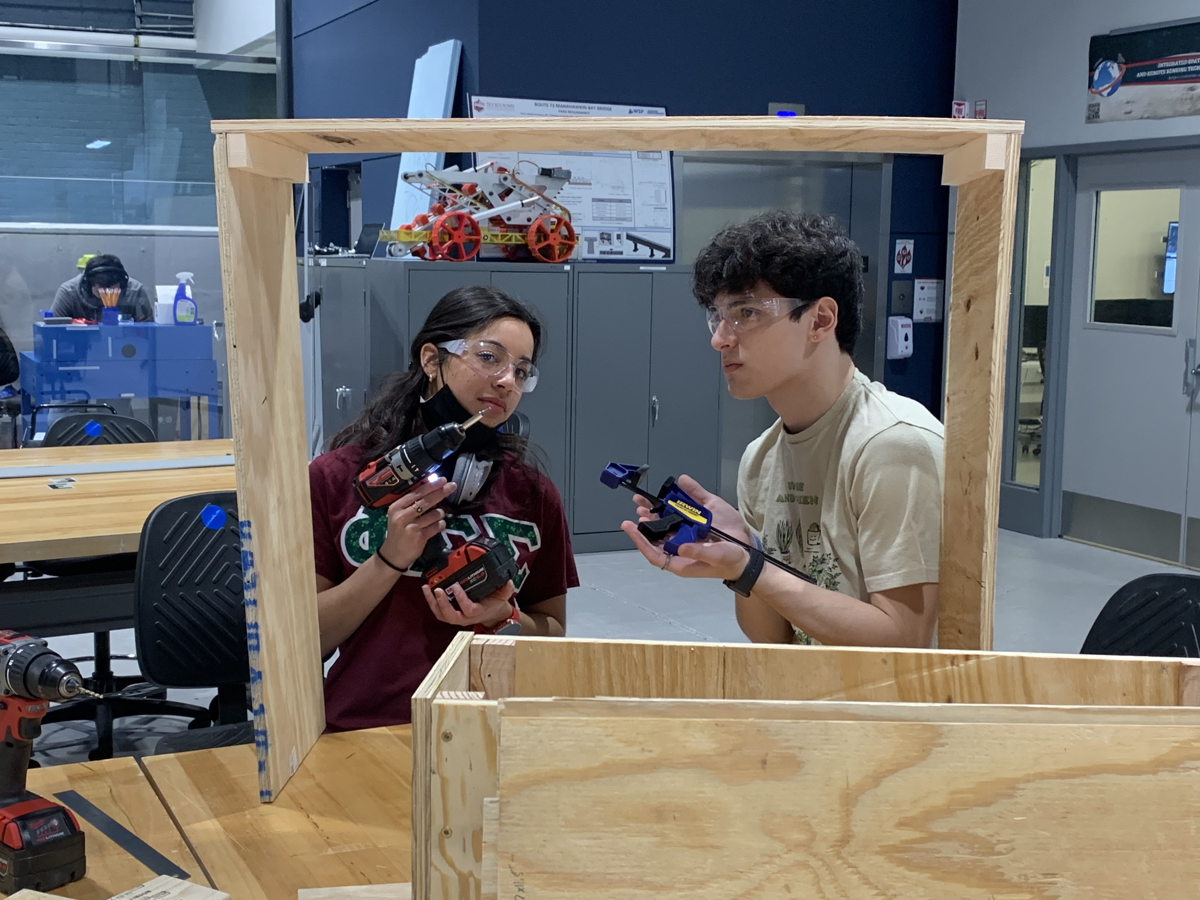 Intellliveggie team working on their smart greenhouse senior design project in the ABS engineering center