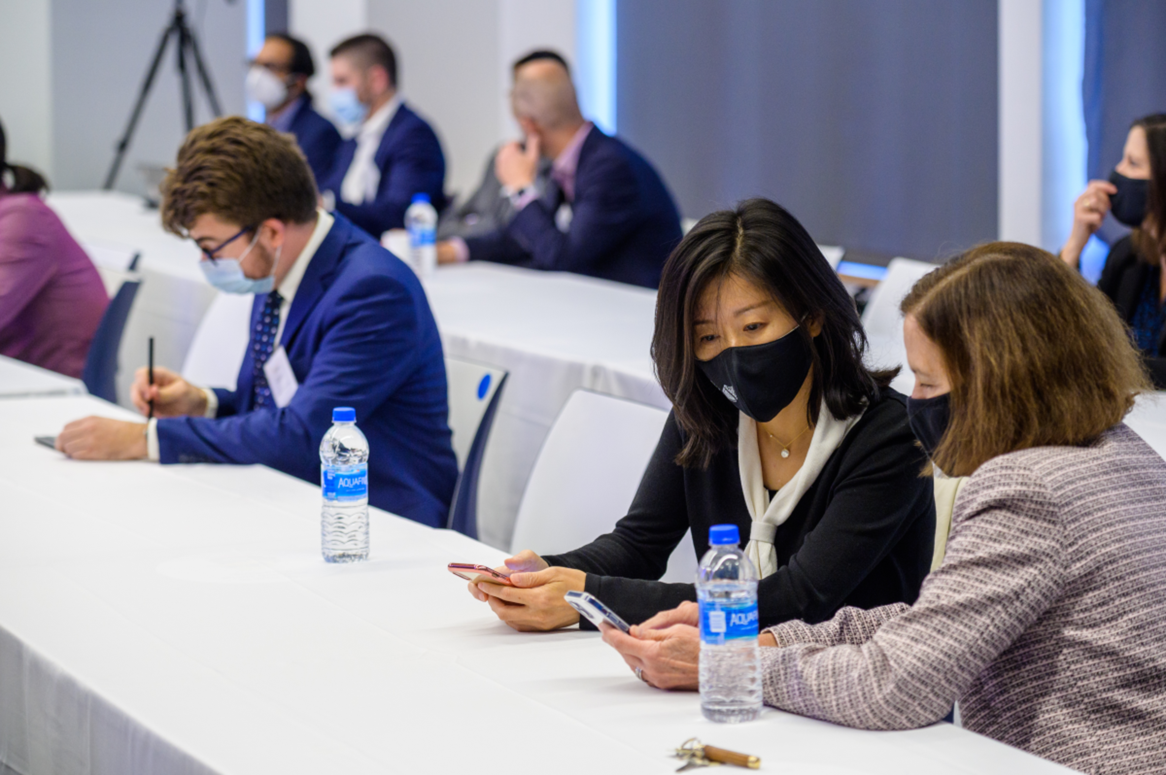 people at tables in a Stevens conference room