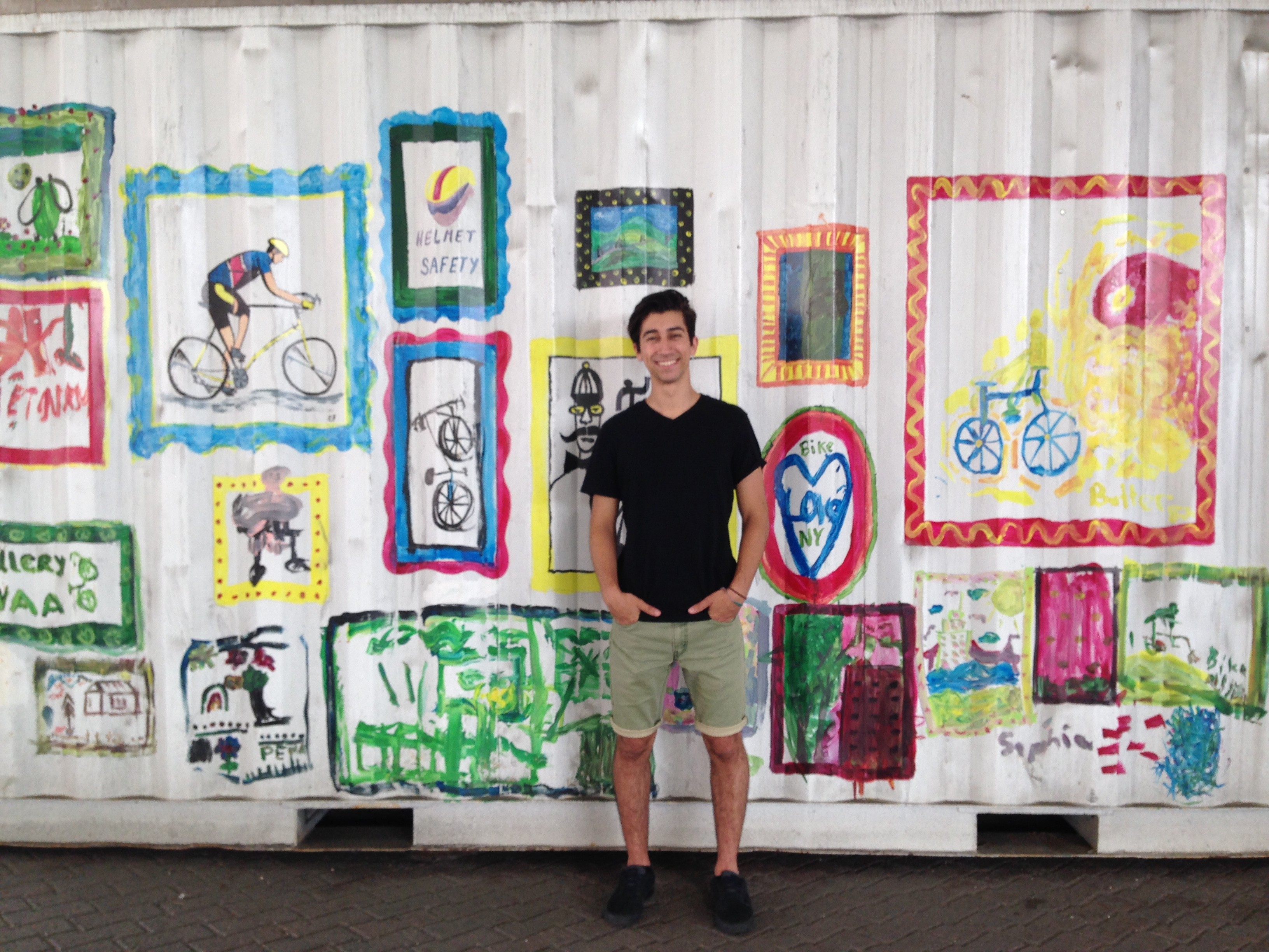 Ryan Bertani standing in front of a mural of bike motifs
