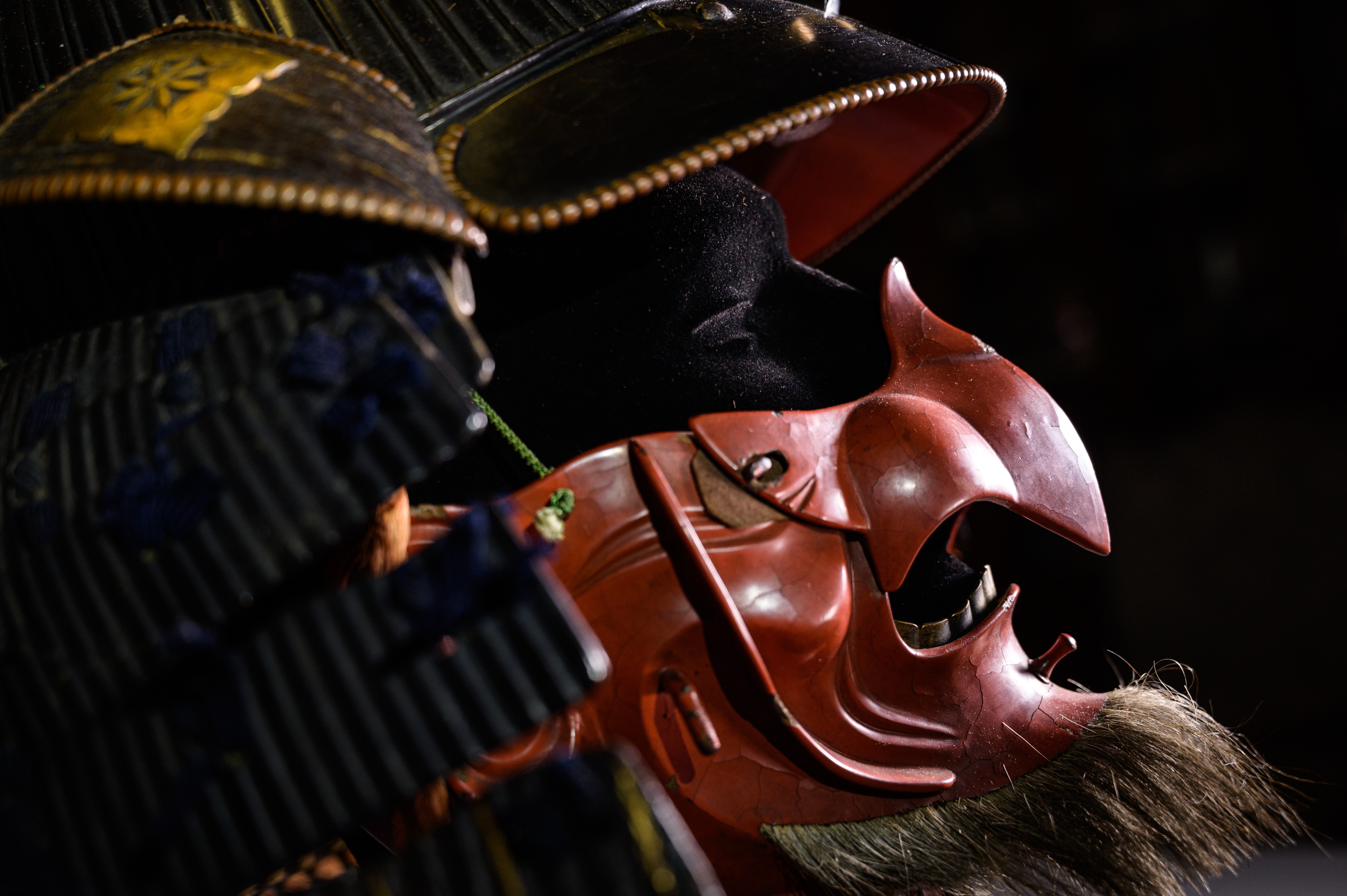 A close-up of the iron samurai helmet and red lacquered face mask