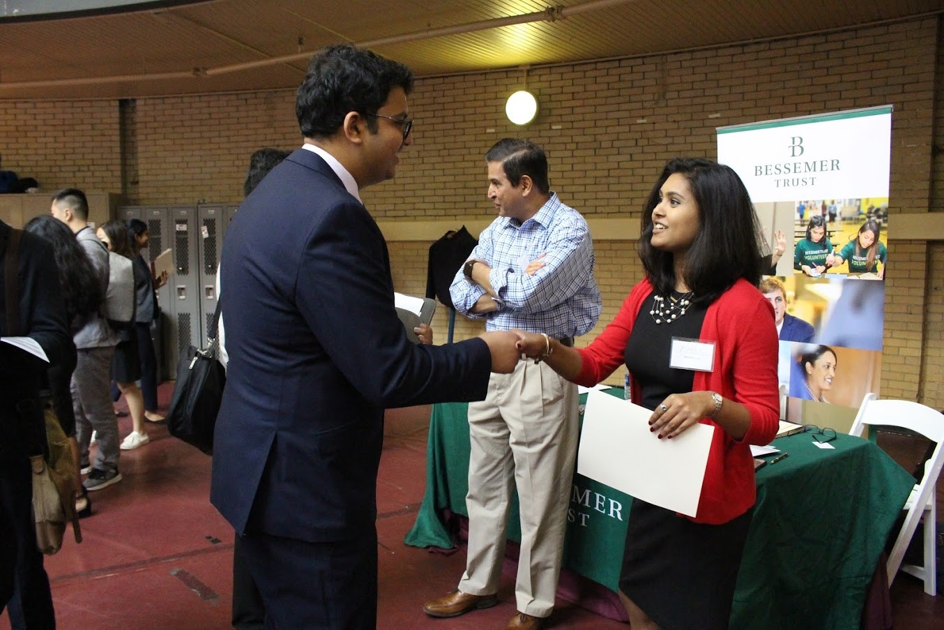 Male Stevens student shakes hands with recruiter from Bessemer Trus