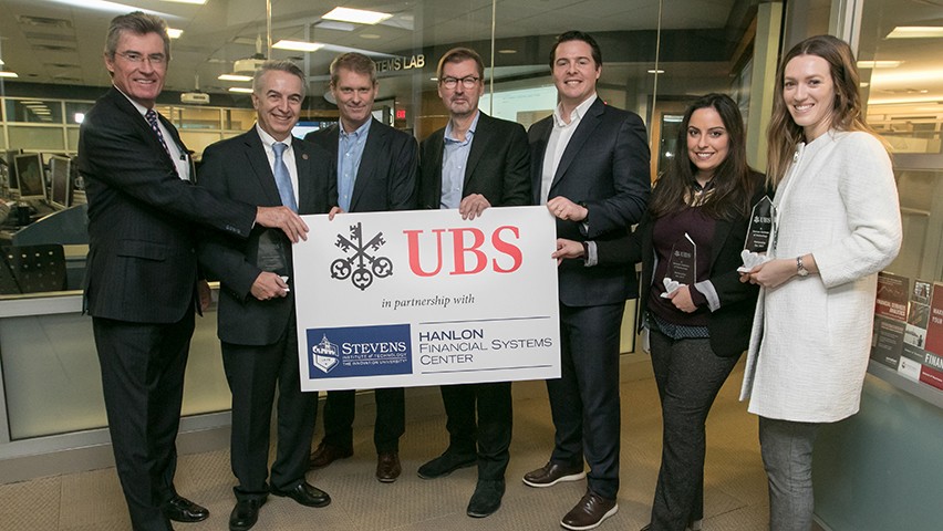 Leadership from Stevens and UBS in front of the Hanlon Financial Systems Lab.