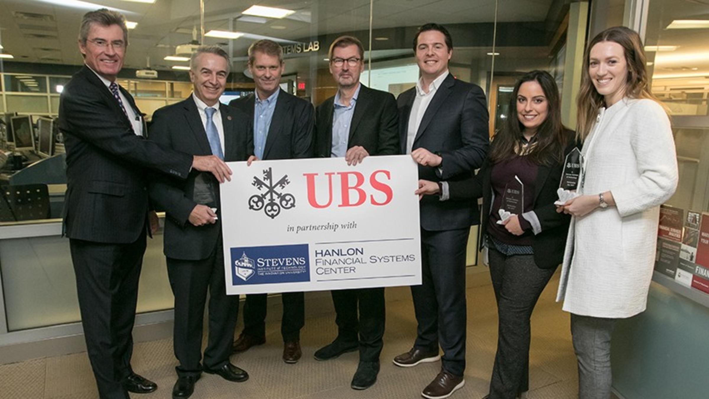 Leadership from Stevens and UBS in front of the Hanlon Financial Systems Lab.