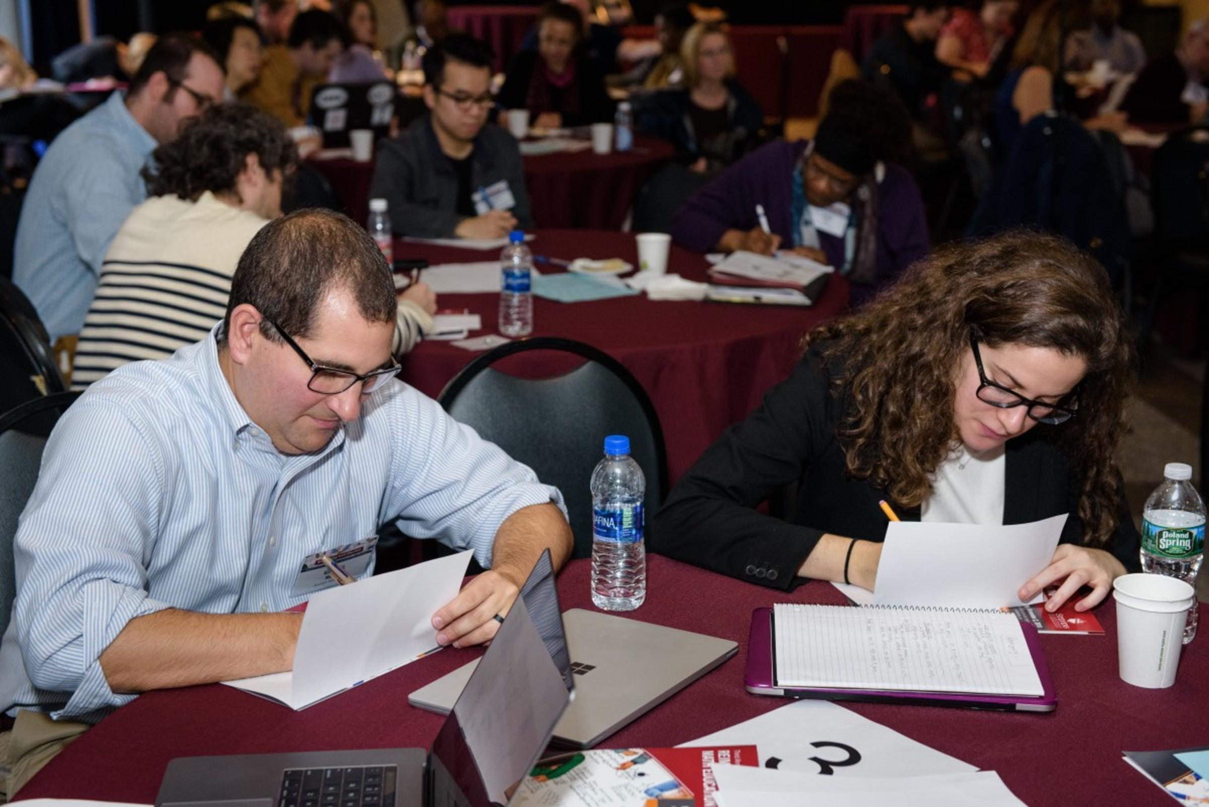 Participants engaged in a hands-on learning activity at the Reimagining Math Education Conference. CREDIT: Jeff Vock