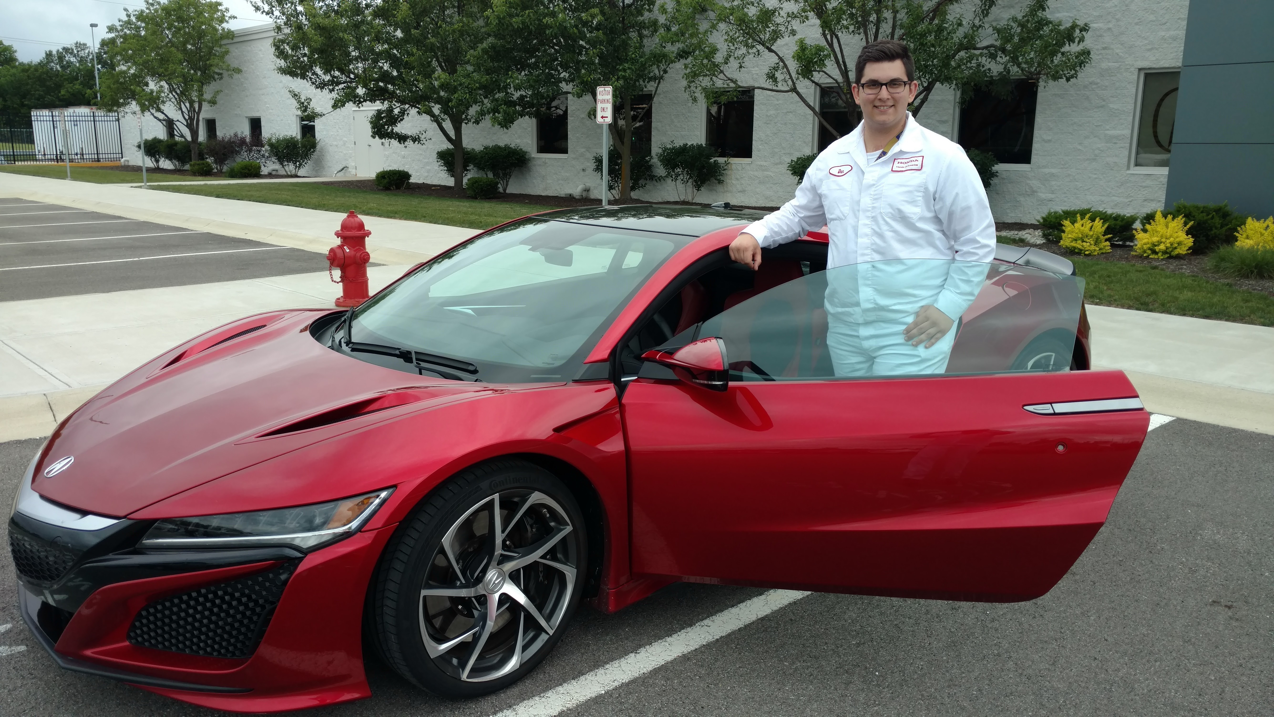 Daniel Kilgore standing in front of a red Acura NSX