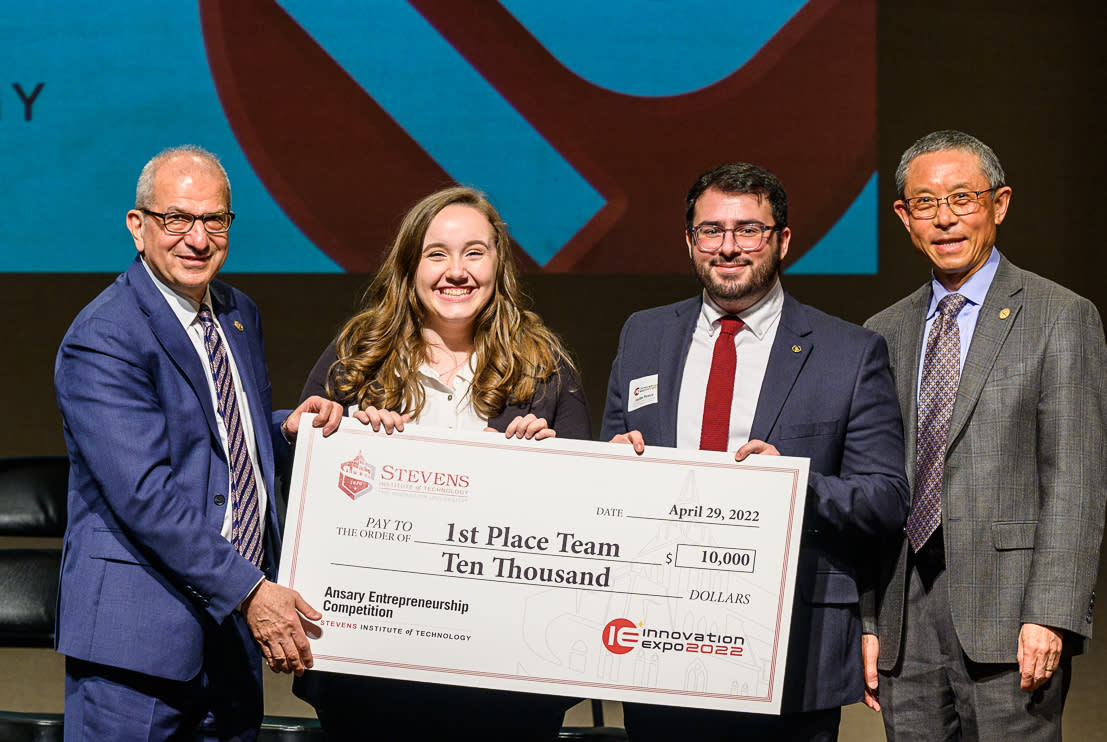 students with a large $10,000 check