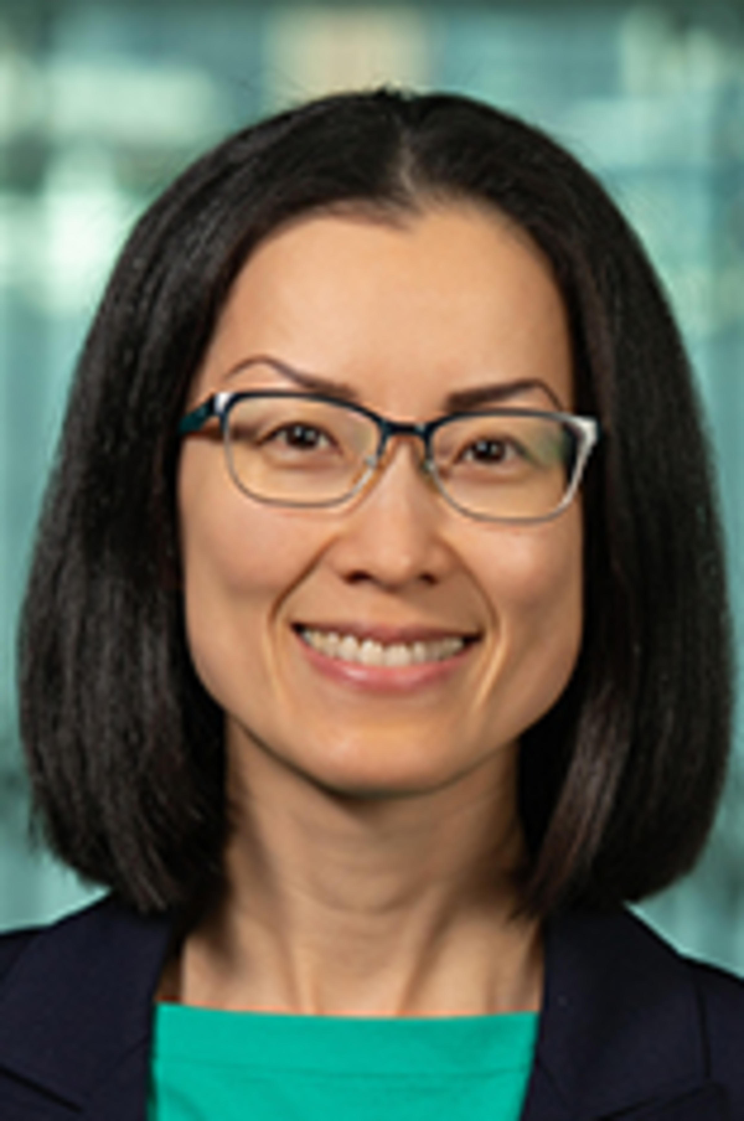 Headshot of Wei Zheng against the New York City skyline.