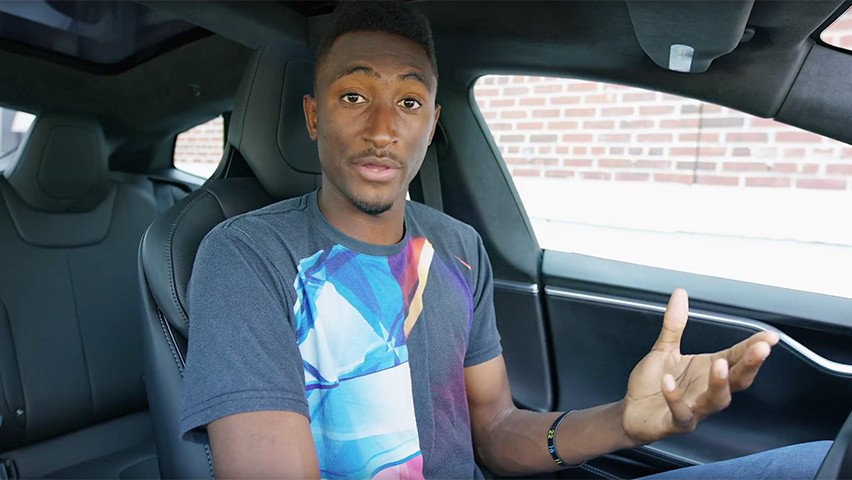 Marques Brownlee behind the wheel of a Tesla.
