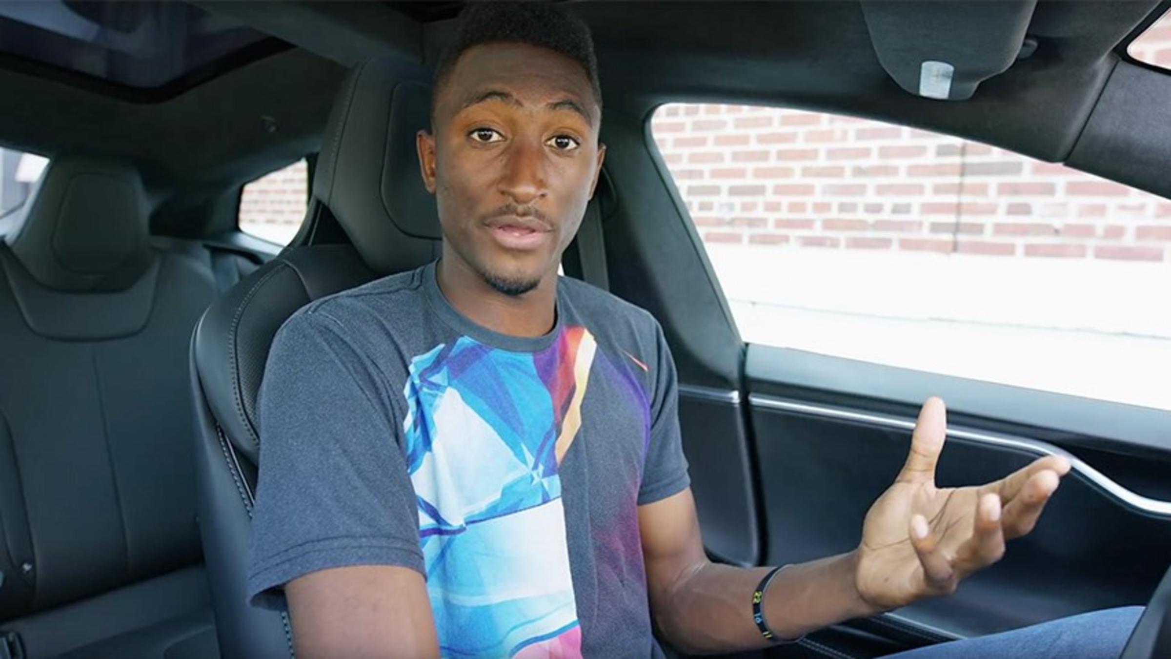 Marques Brownlee behind the wheel of a Tesla.