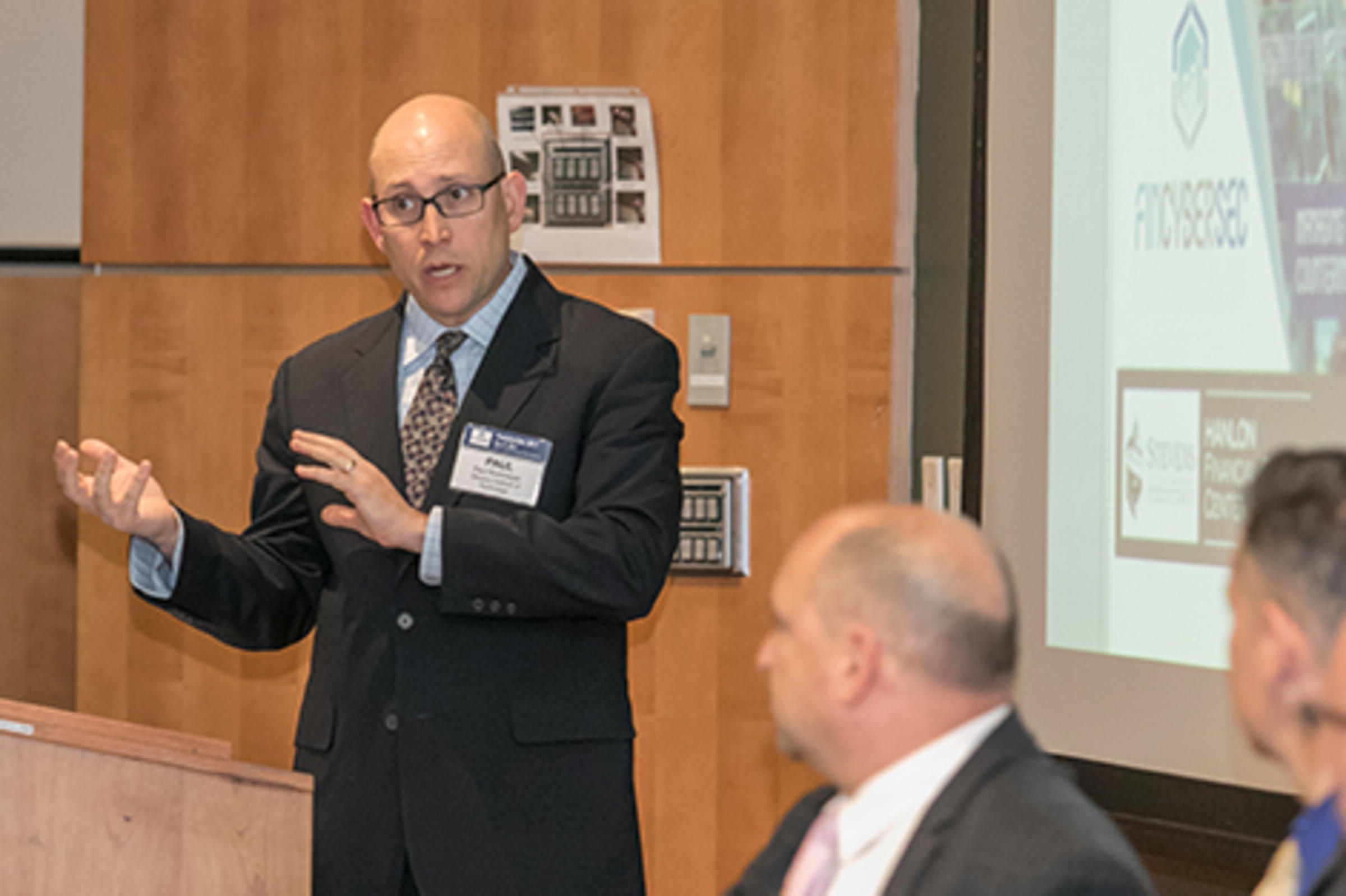 Dr. Paul Rohmeyer introducing a panel of speakers at the conference.