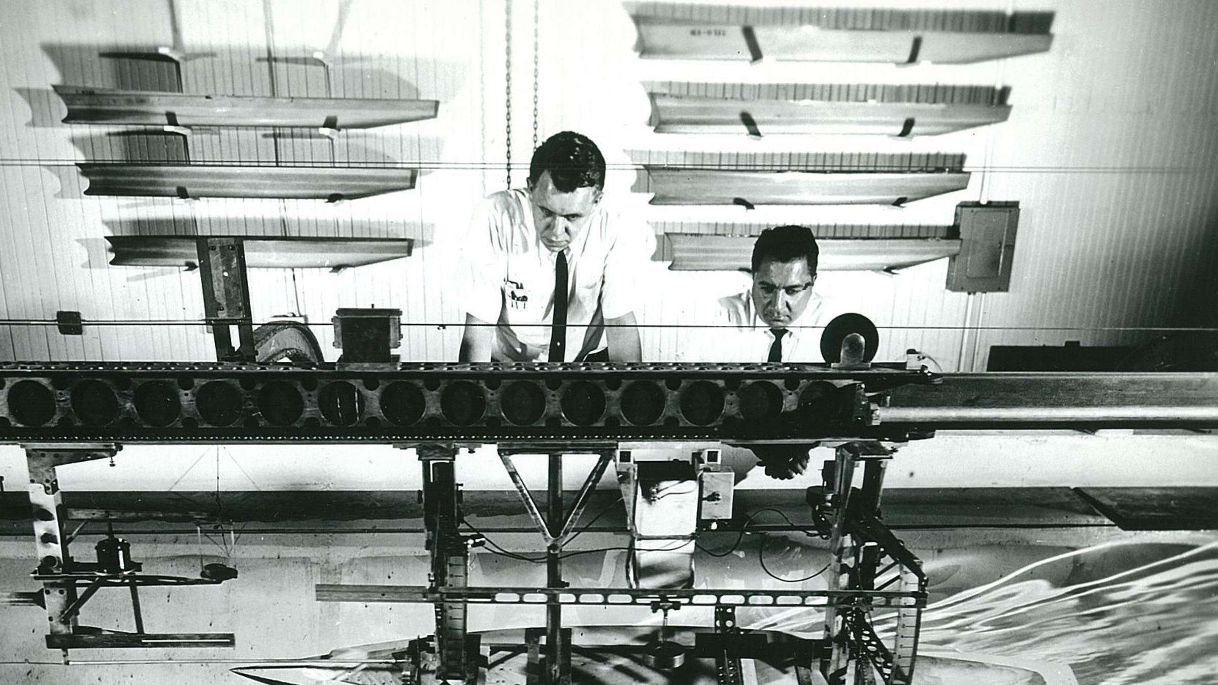 Daniel Savitsky M.S. ’52, right, and former Davidson Laboratory director John Breslin test a model of the yacht Constellation in 1964