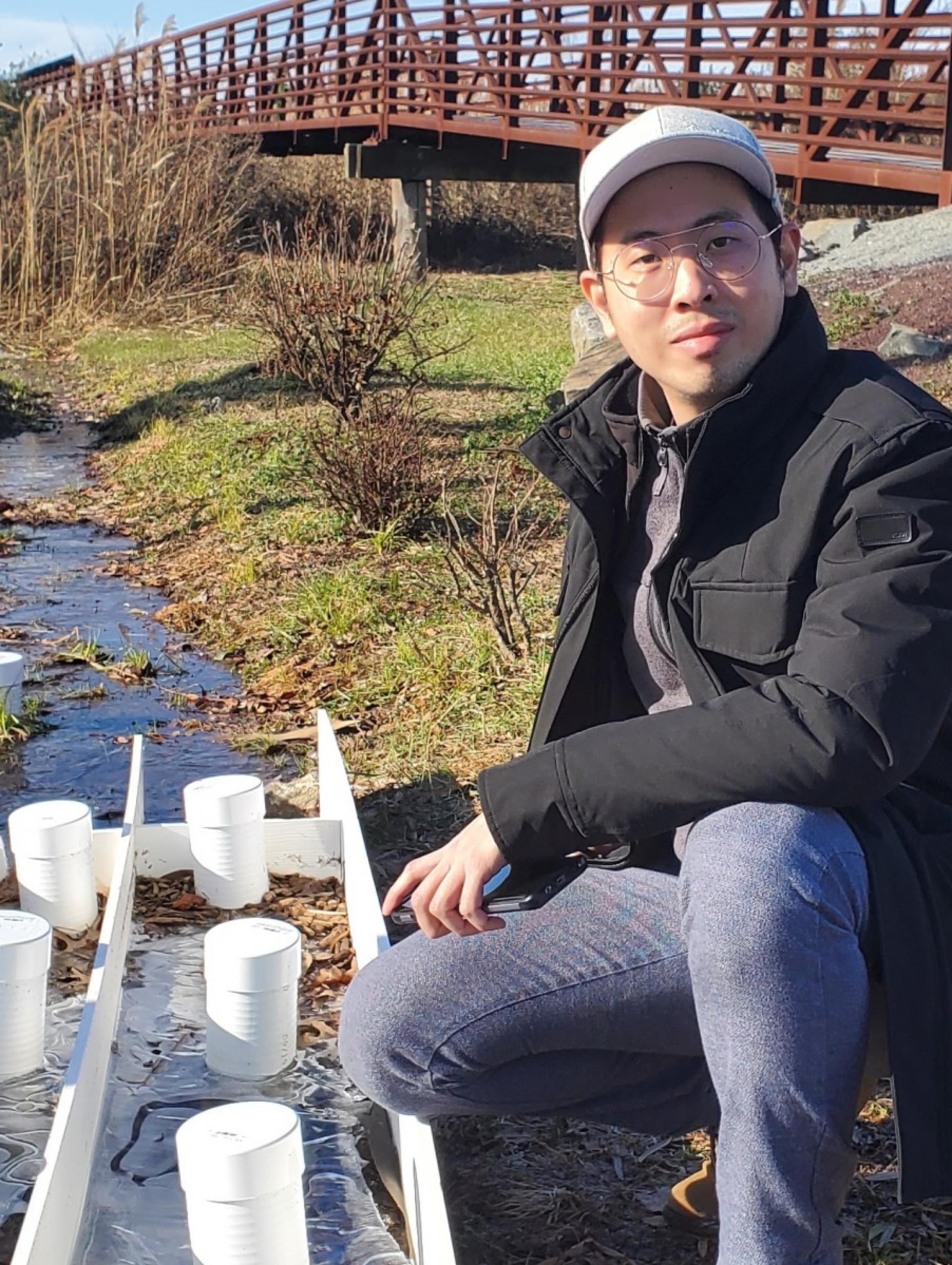 Student working beside waterway