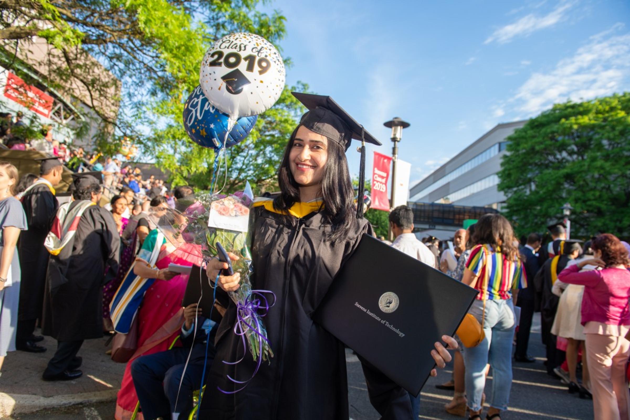 A member of the Stevens Graduate Class of 2019 proudly displays her diploma