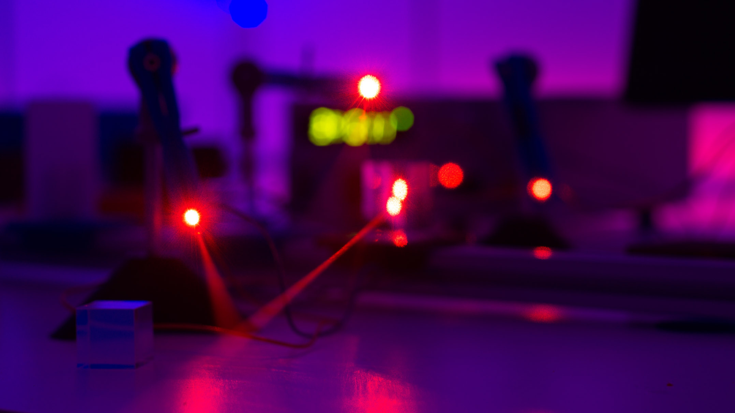 Laser beams in a photonics lab in the Department of Physics.