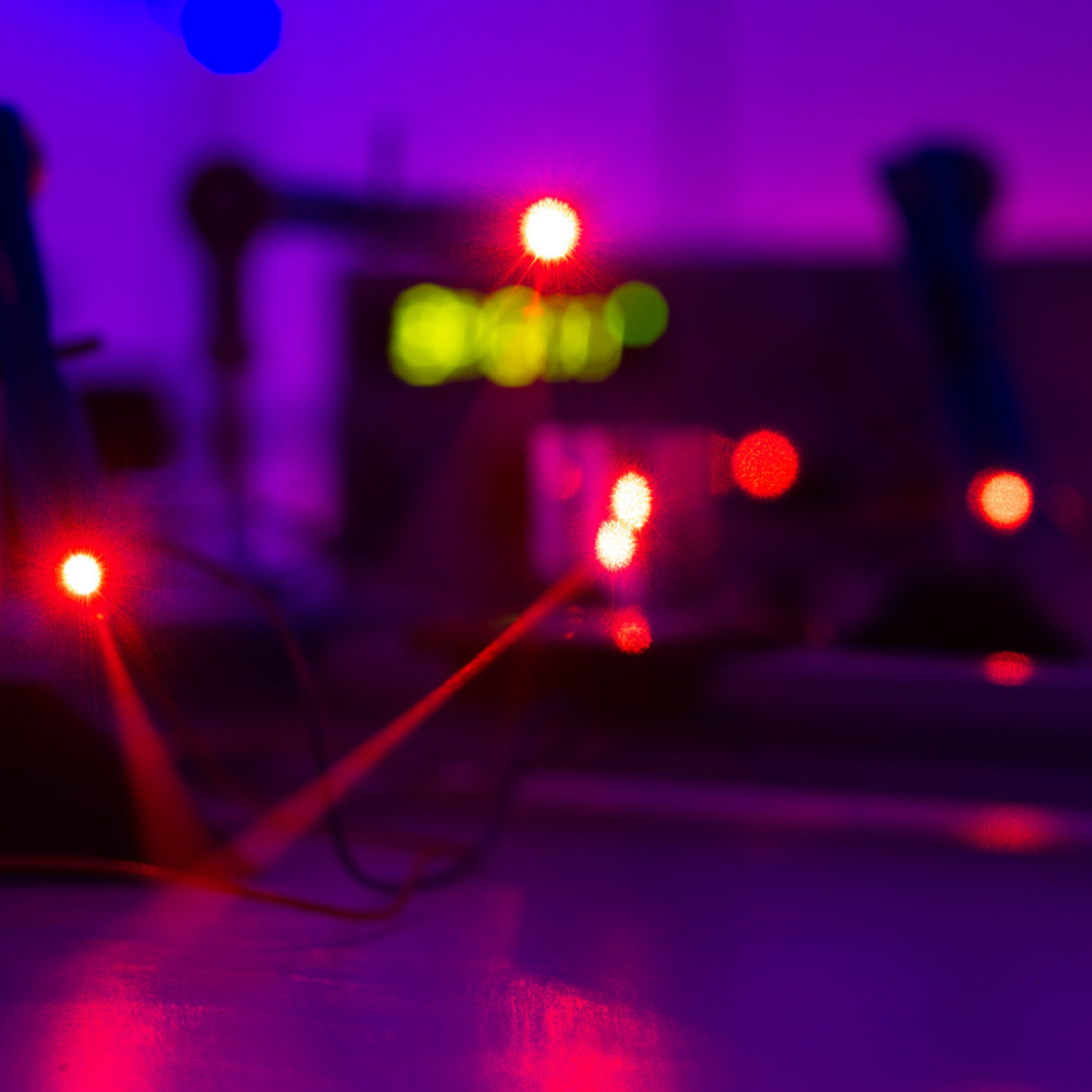 Laser beams in a photonics lab in the Department of Physics.