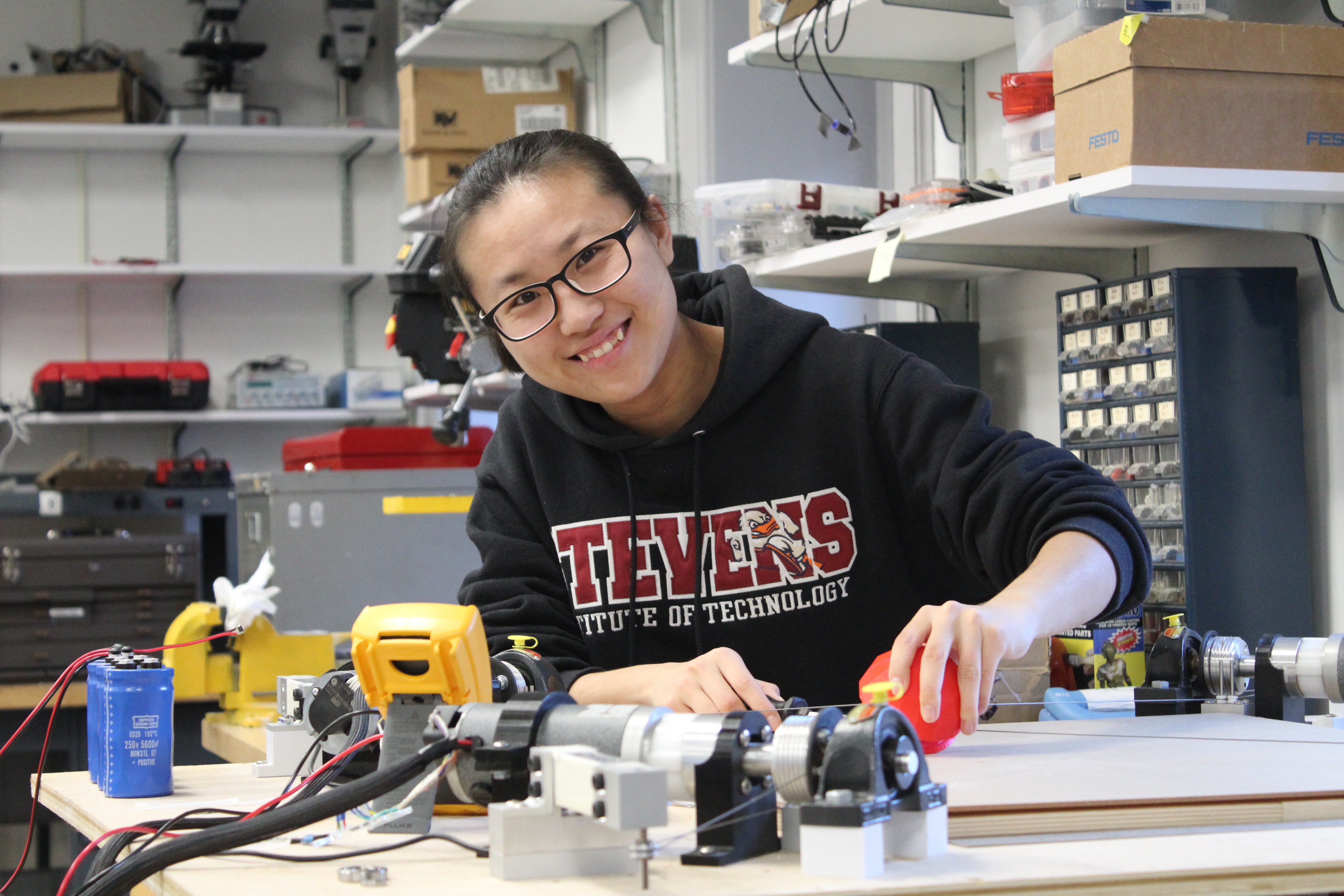 Qianwen Zhao, using her robot-assisted haptic joystick therapeutic device in the Wearable Robotic Systems Laboratory.