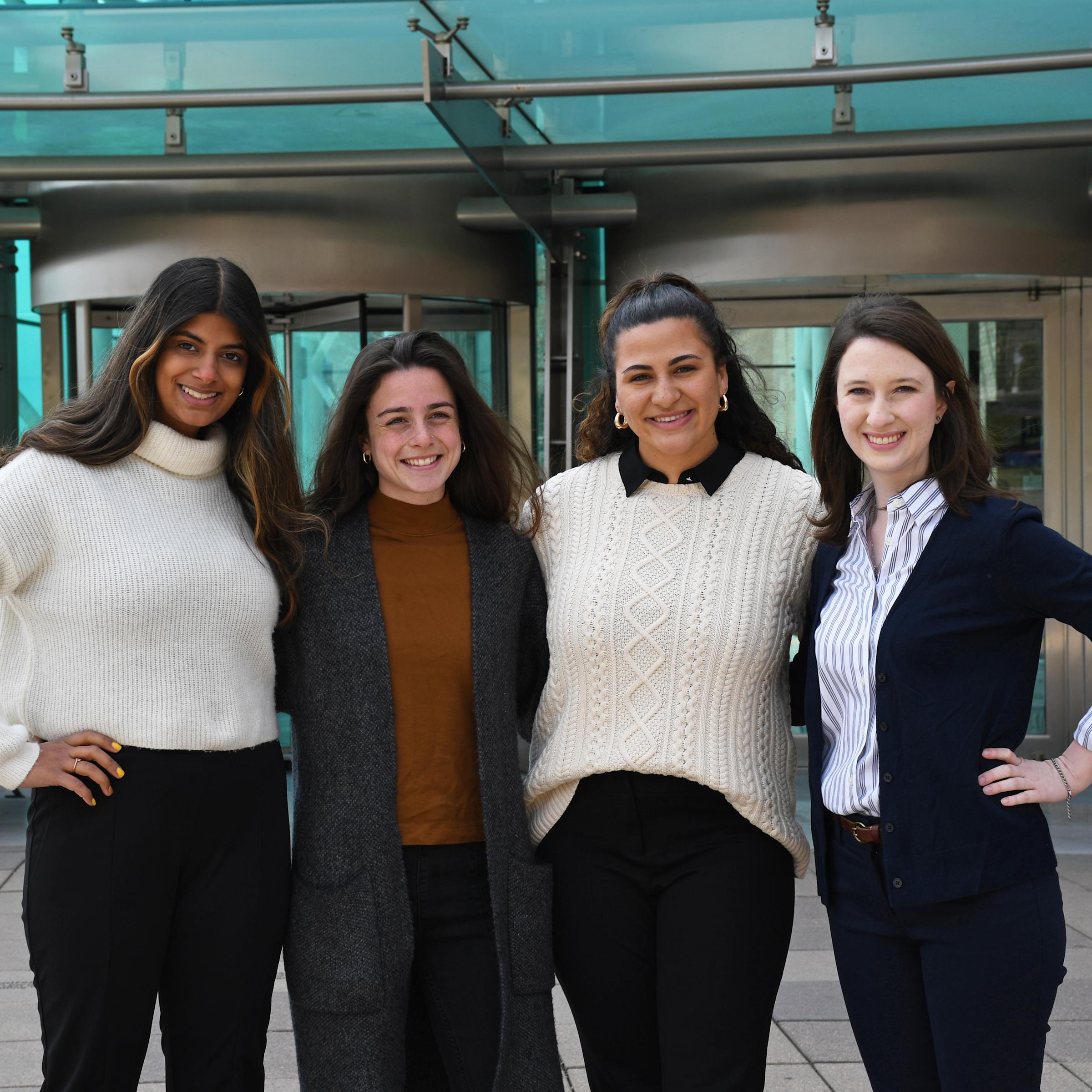 Four female students standing in front of Babbio Center.