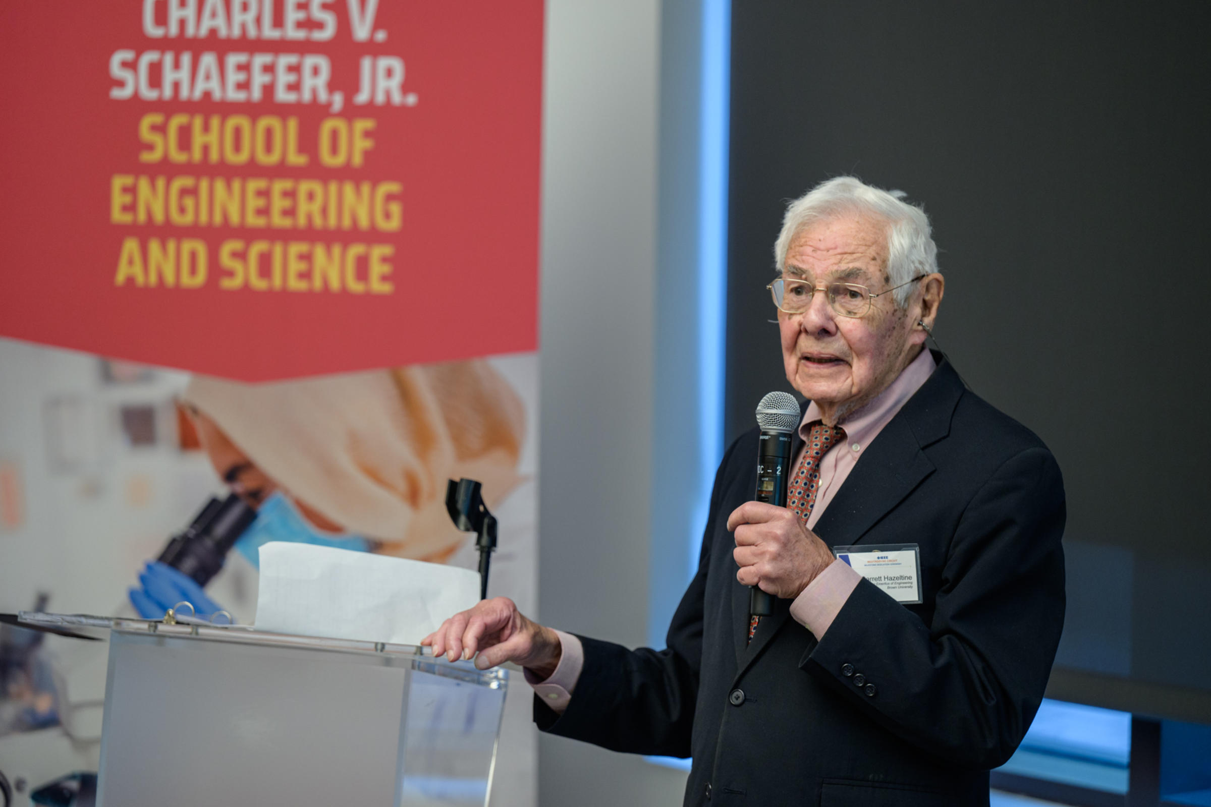 Barrett Hazeltine speaks from behind a podium.