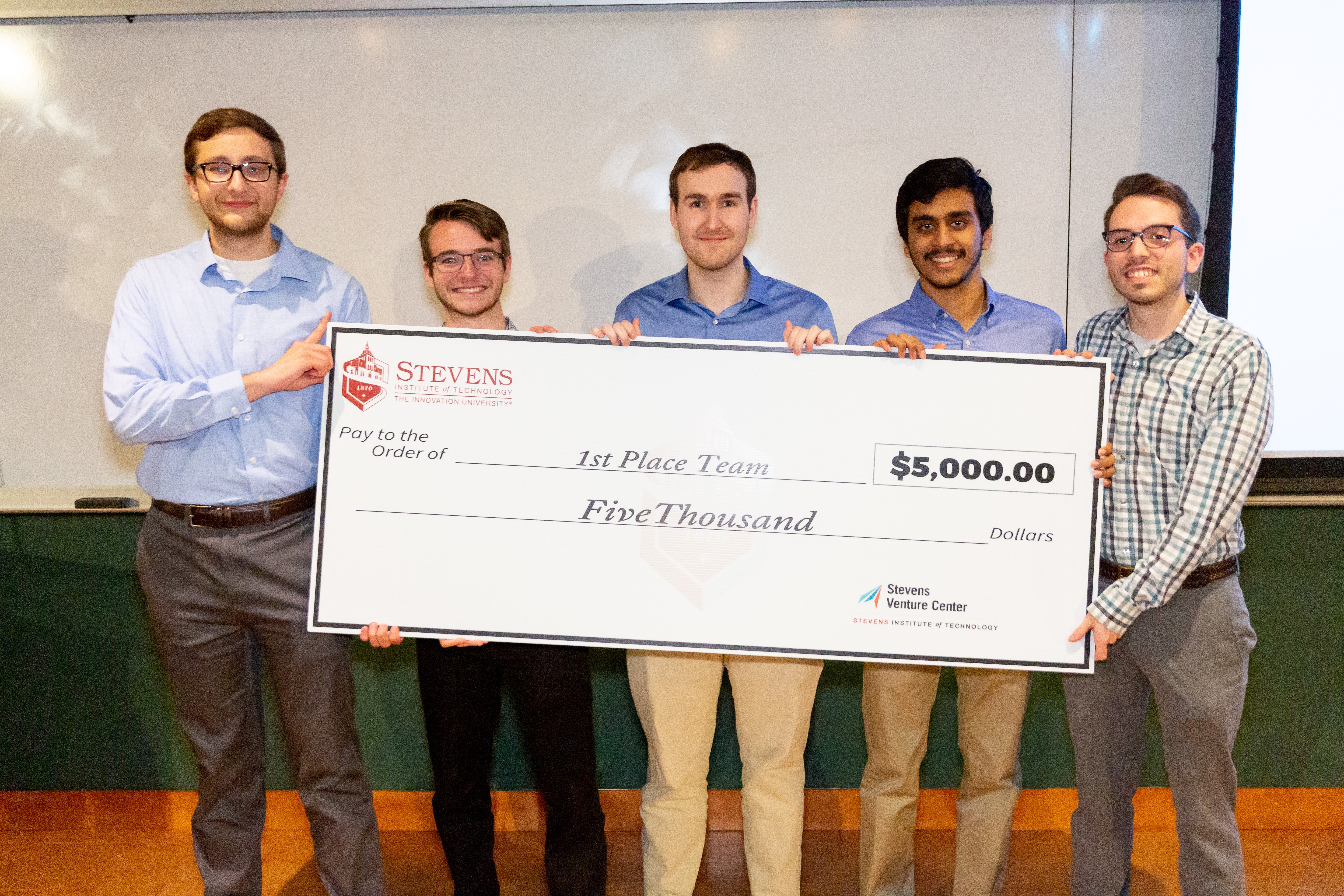 Team R3, comprised of students from Stevens, took first prize in the 2019 HealthTech Hackathon. Team members pose with a ceremonial check.