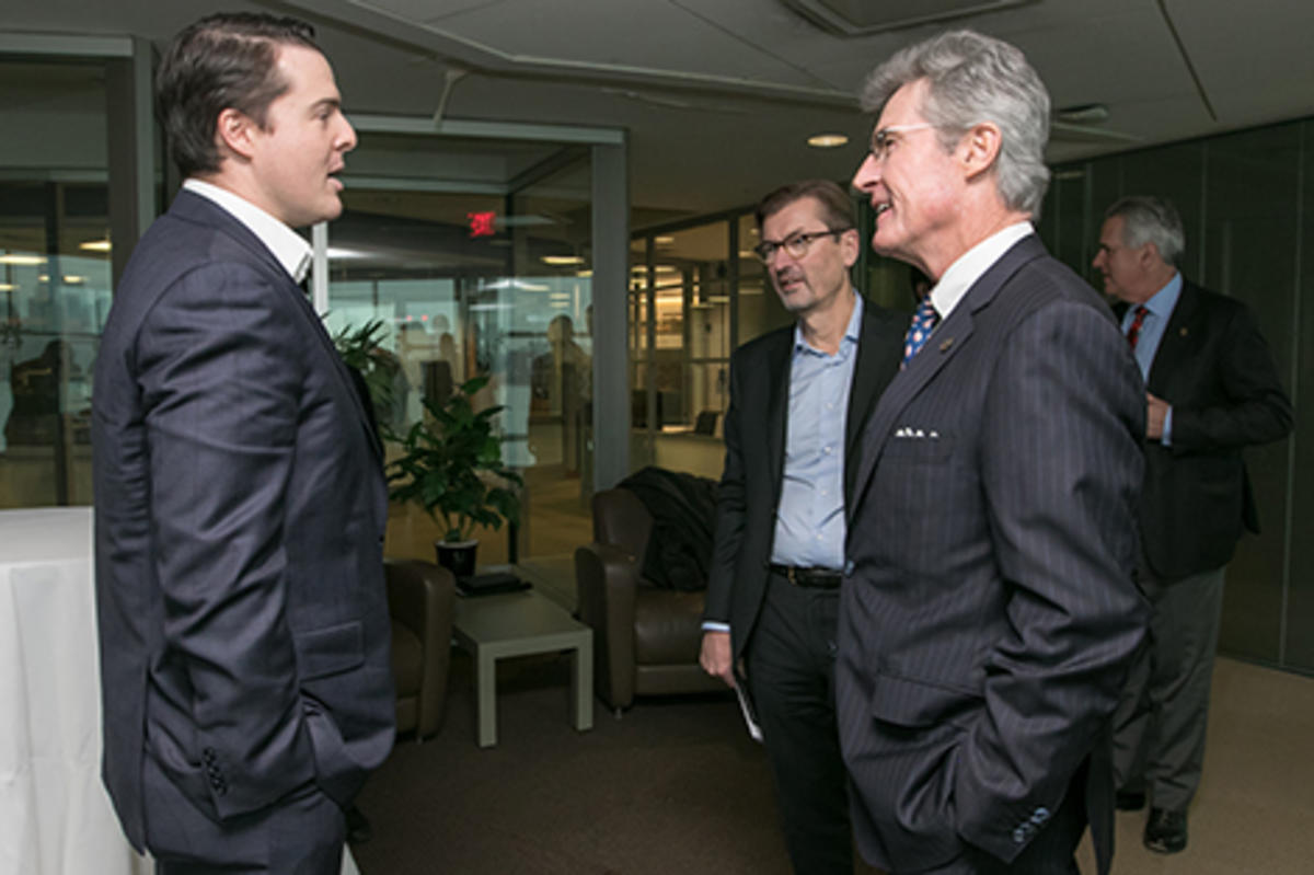 Leaders from Stevens and UBS chatting in the Babbio Center.