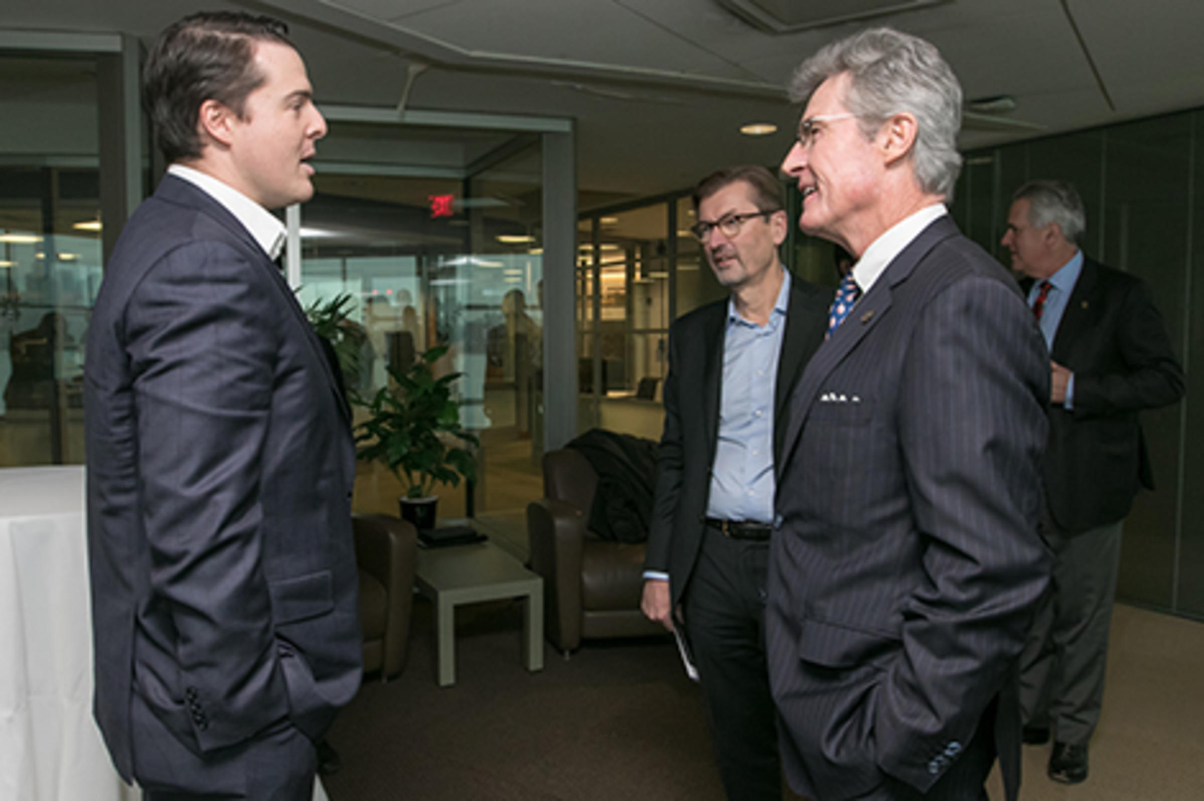 Leaders from Stevens and UBS chatting in the Babbio Center.
