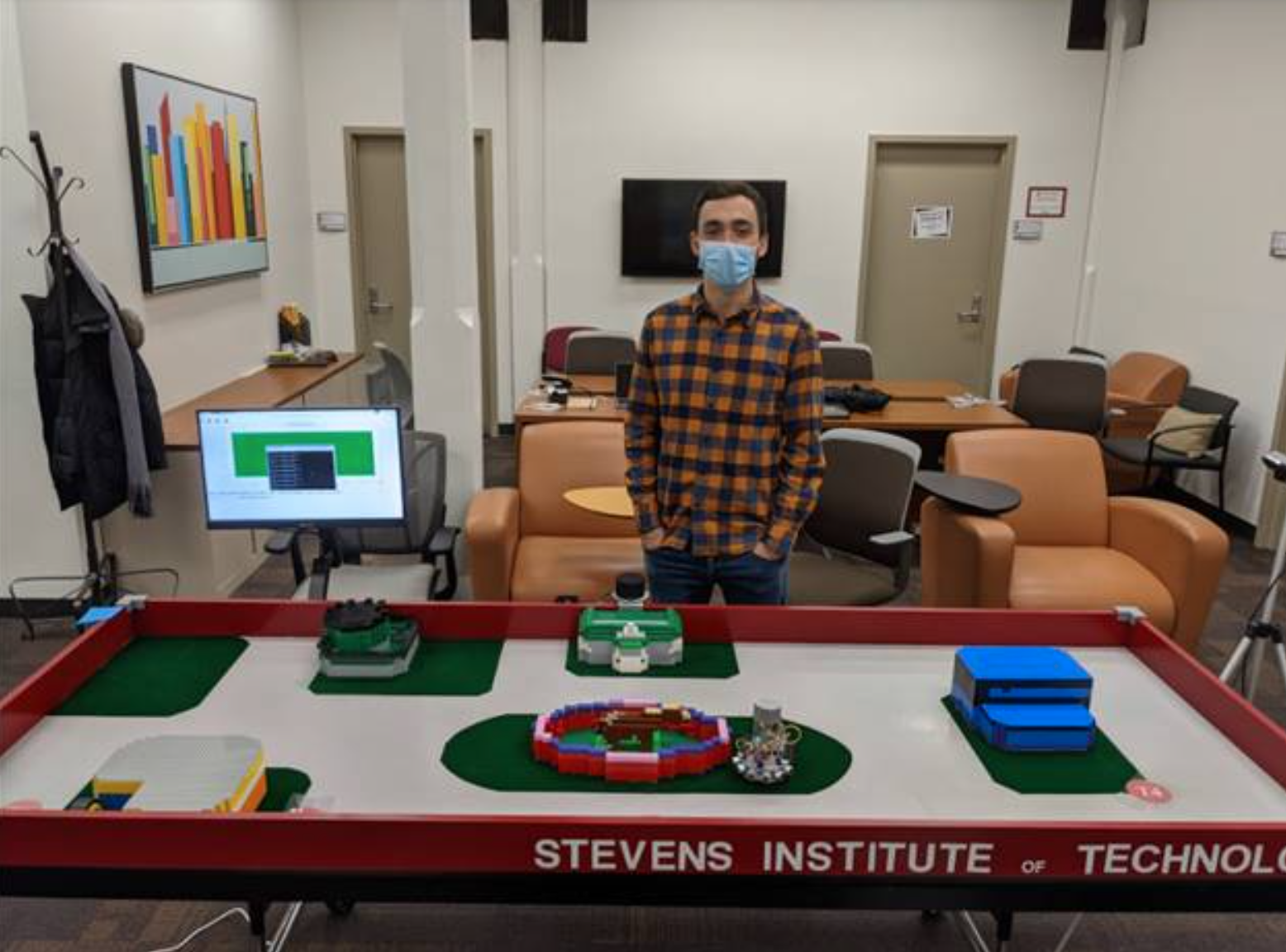 photo of student in front of Stevens campus simulation