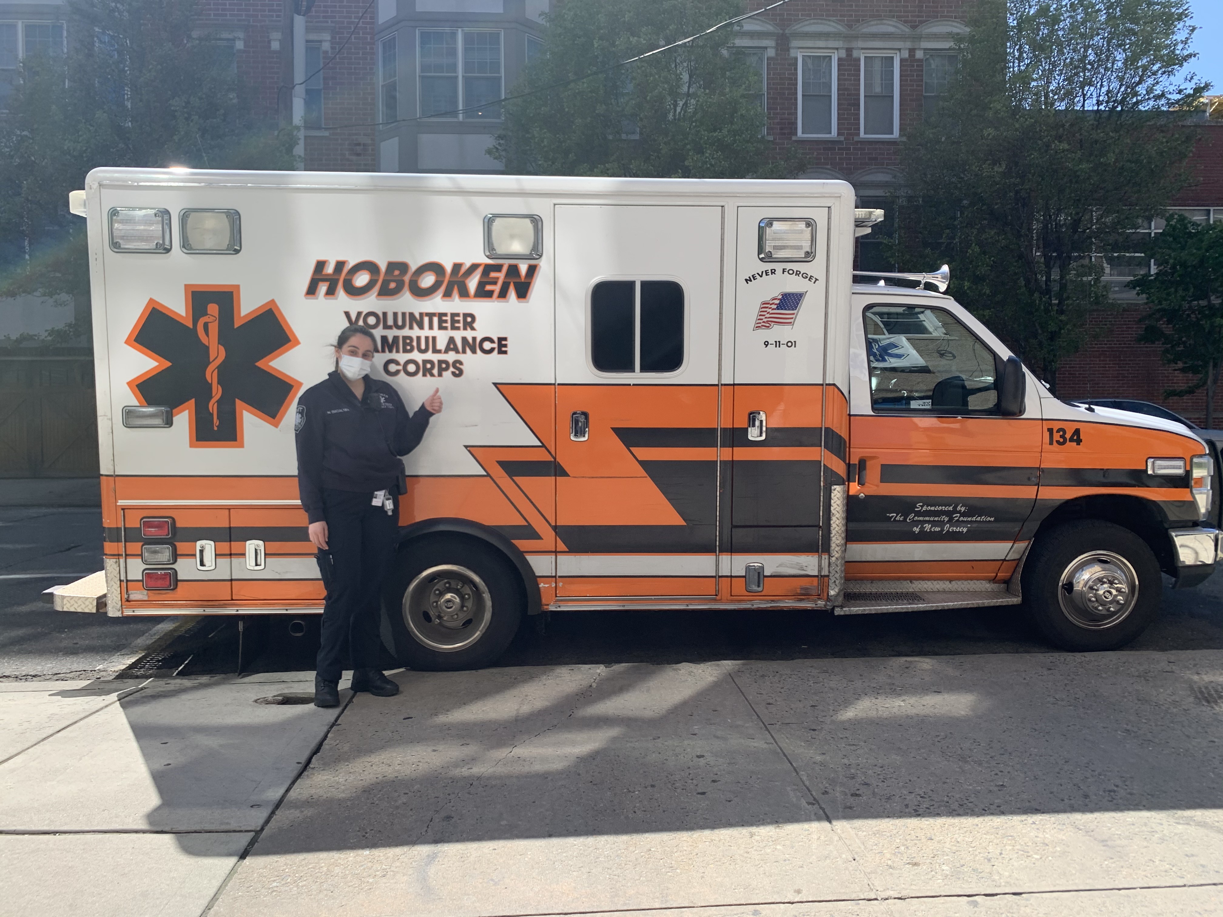 Nicole Badalyan in front of a Hoboken ambulance