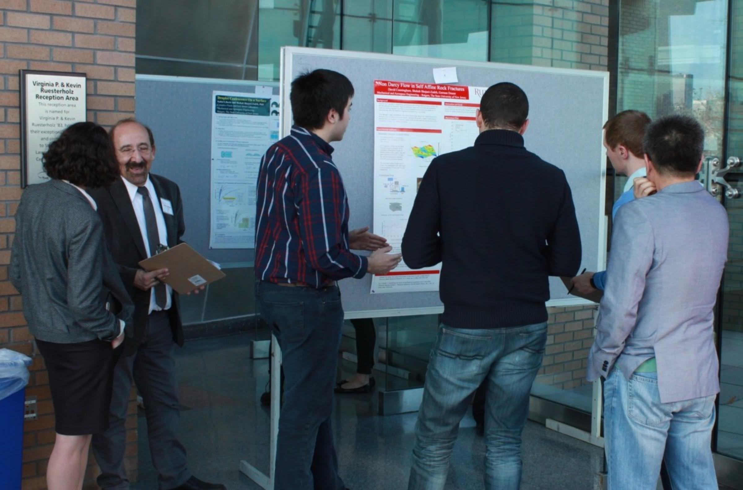 Workshop participants discussing research on student's posters