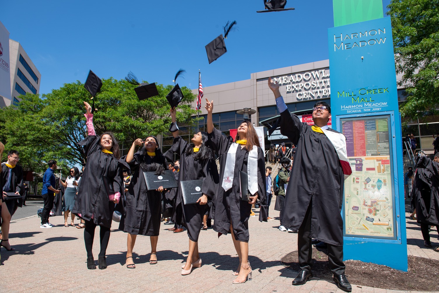graduates throwing hats in air