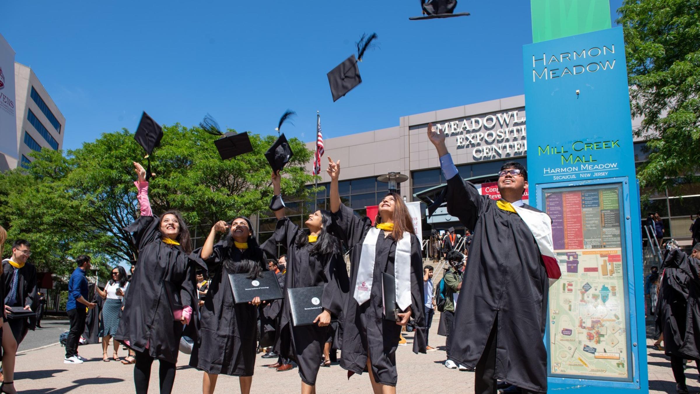 graduates throwing hats in air