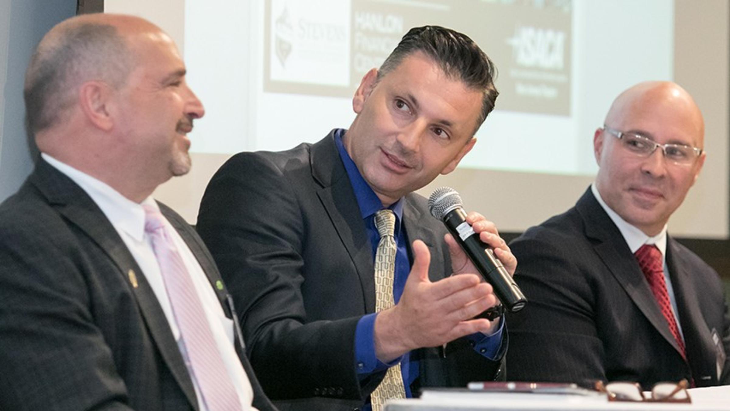 Three panelists answering questions during the FinCyberSec conference in Hoboken.