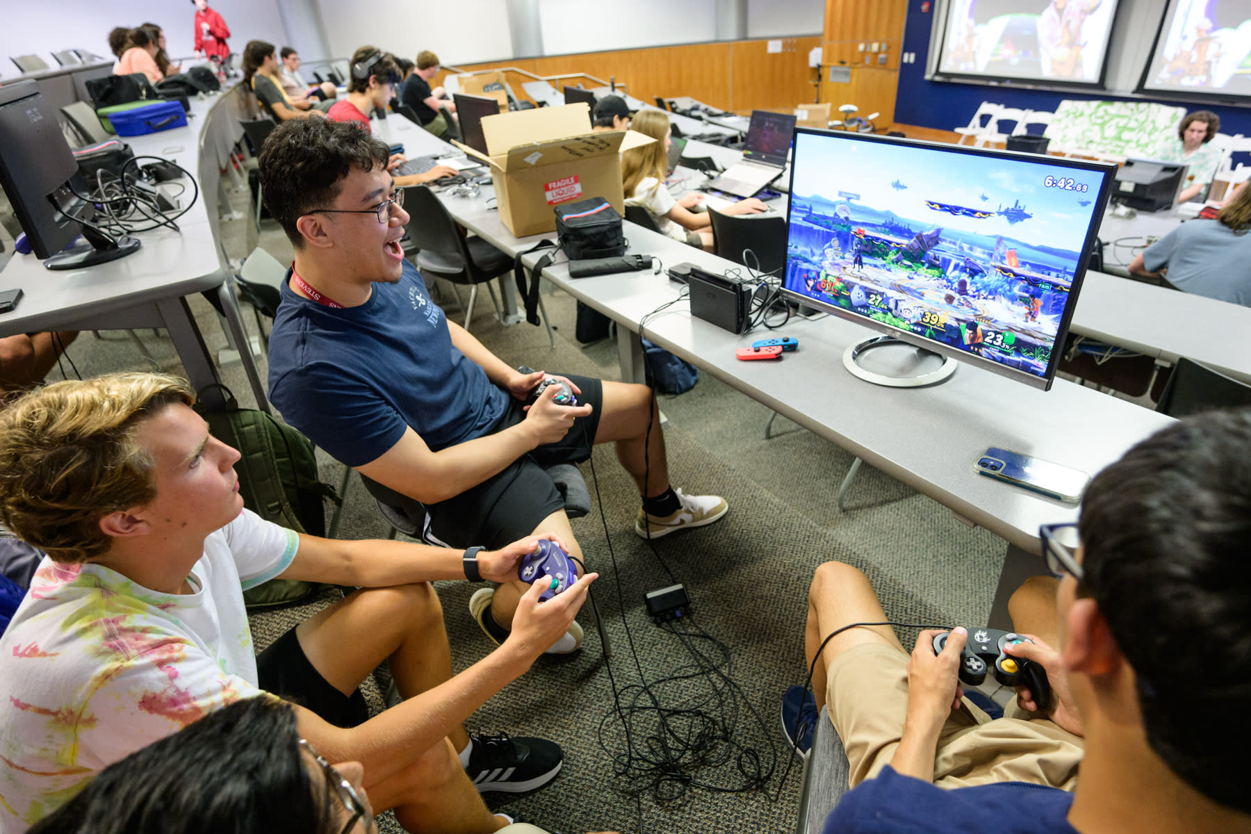 Students play competitive video games during an orientation event.