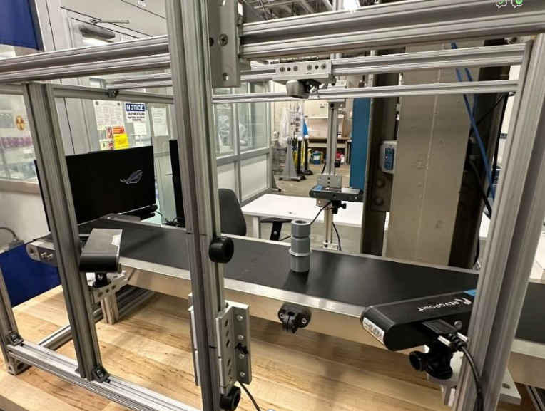 Multi-sensor 3D inspection setup with laser scanners oriented to ensure full surface coverage of the sample, enabling defect detection, dimensional analysis, and assembly verification. 