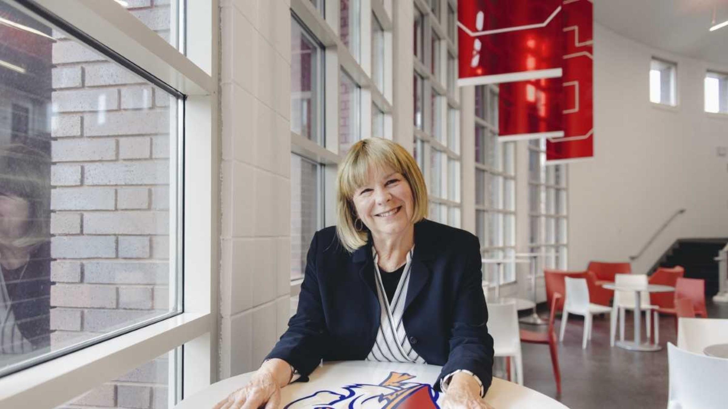 Coach Linda Vollkommer-Lynch sitting at a table