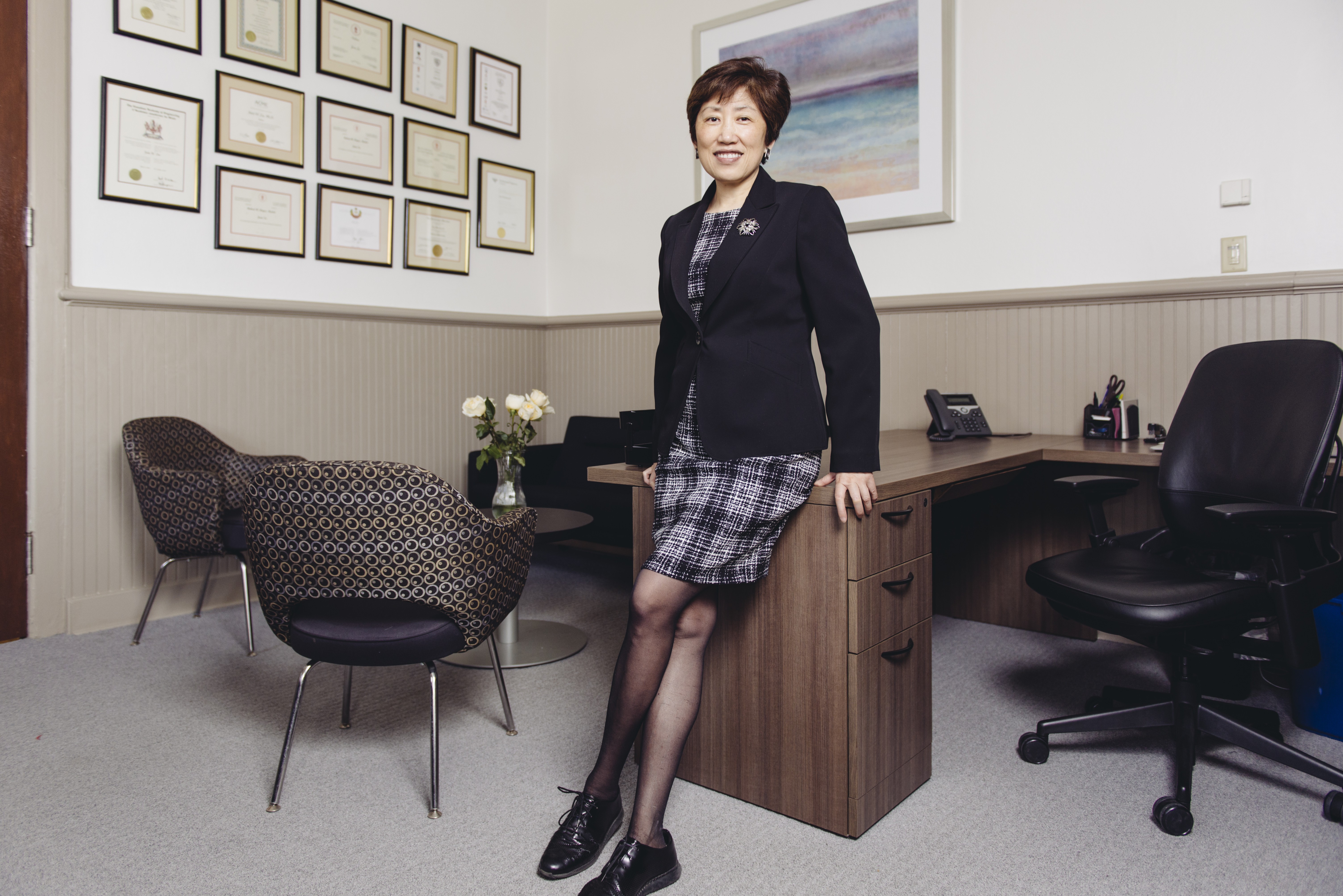 Dean Zu leaning on a desk