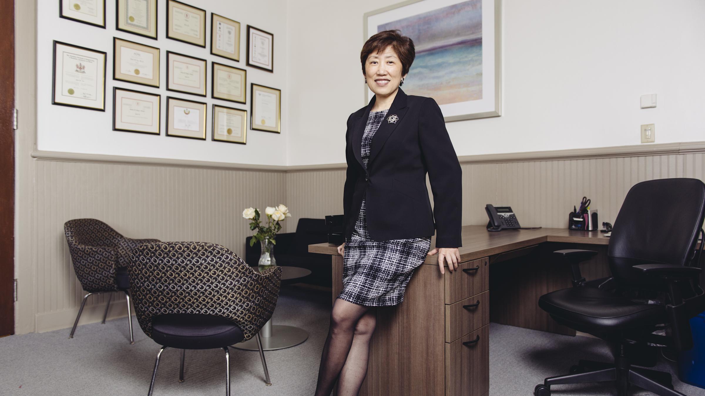 Dean Zu leaning on a desk