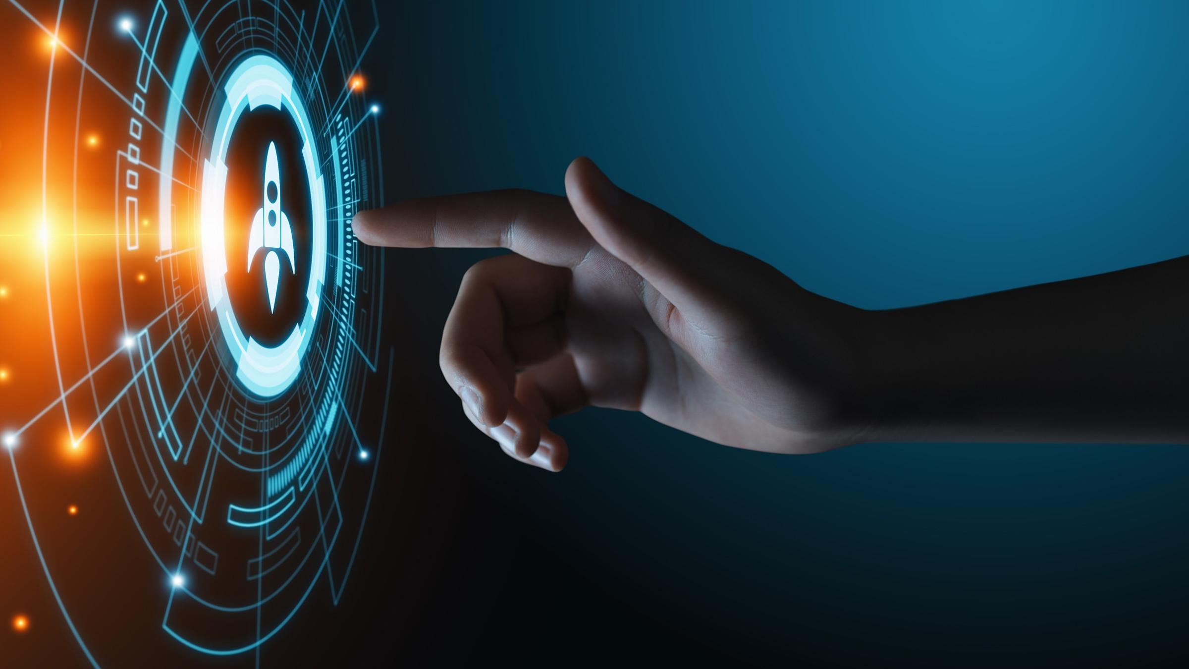 finger touching button with rocket ship on it