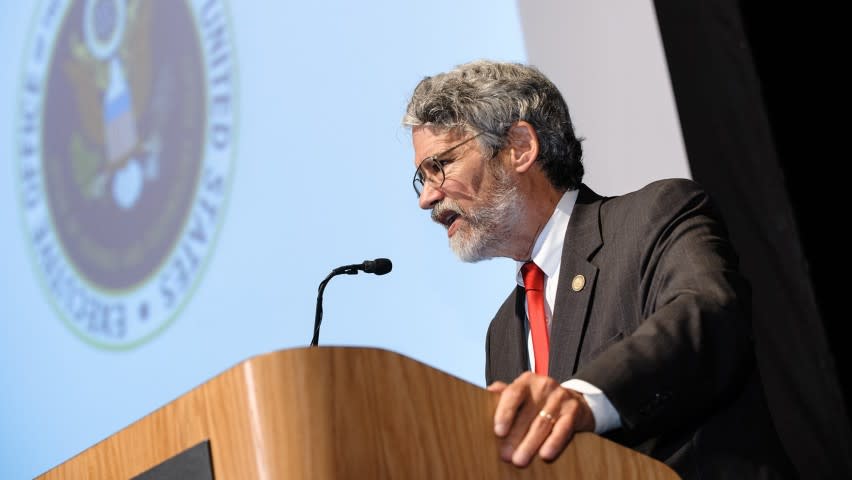 Dr. John P. Holdren speaking at a podium