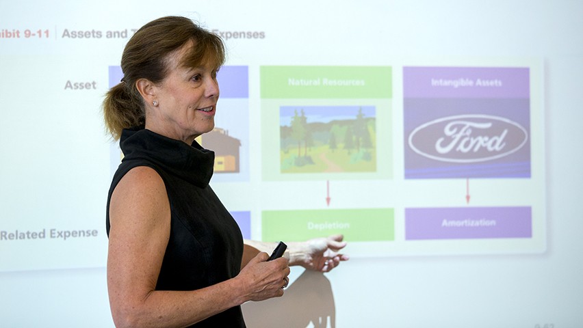 Dr. Elaine Henry in front of a projection showing accounting data in a classroom