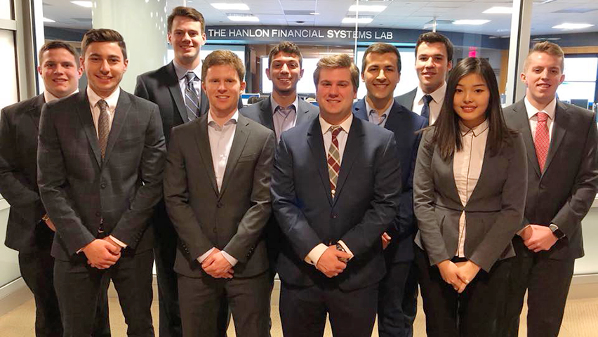 A group of students in professional dress outside the high-tech Hanlon Lab at Stevens.
